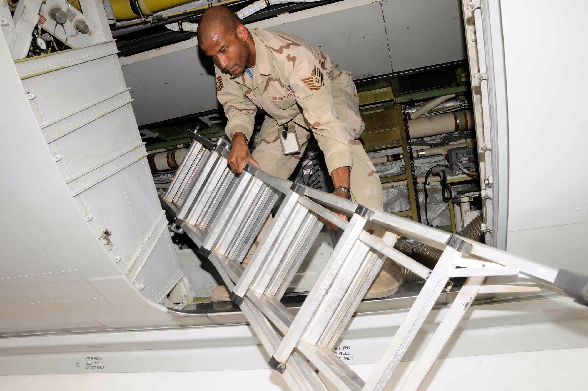 Tech. Sgt. Kevin Reid performs maintenance on a plane in Southwest Asia May 19. Sergeant Reid is a Joint-STARS crew chief. (U.S. Air Force photo/Senior Airman Domonique Simmons)
