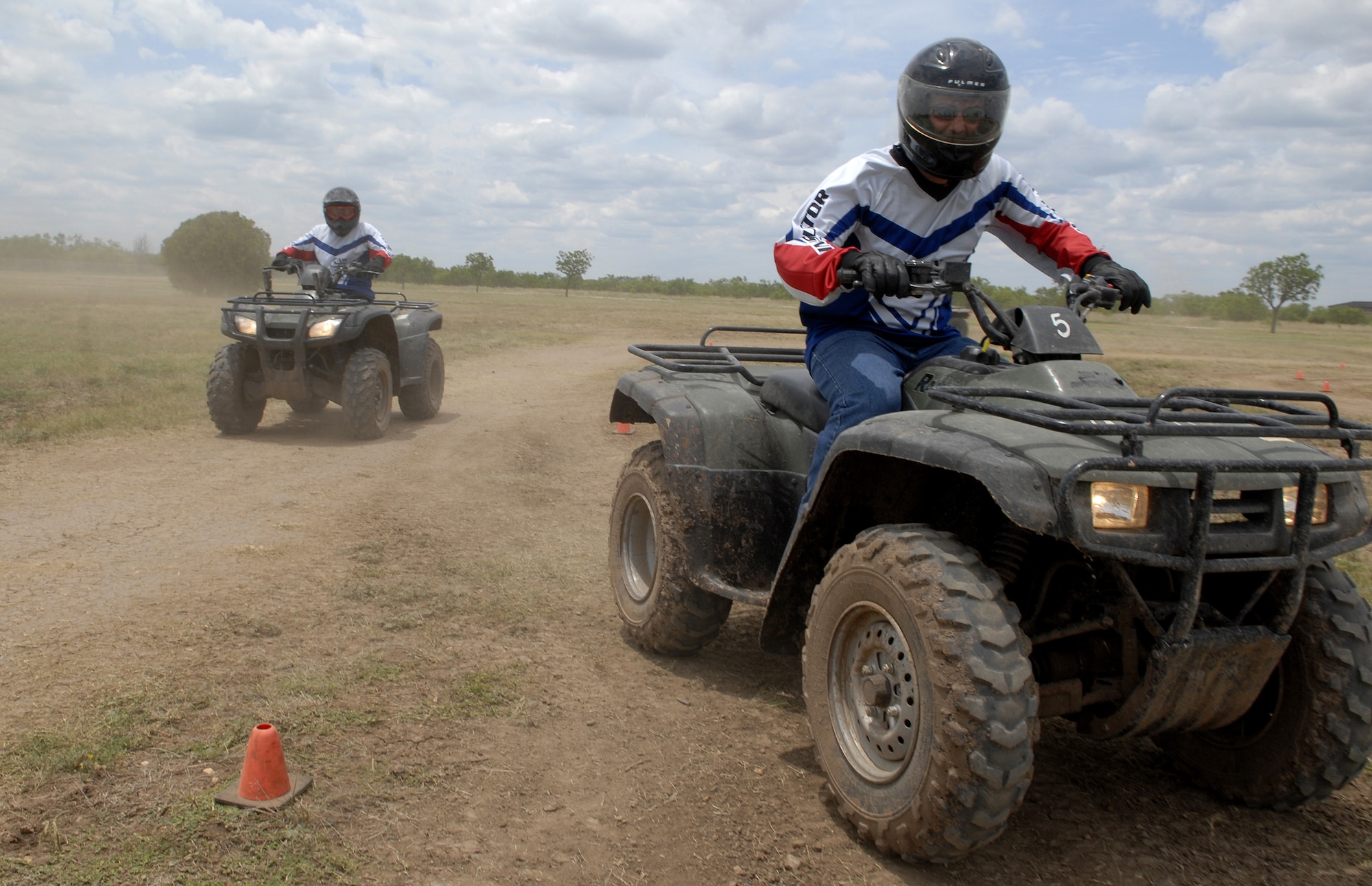 Staff Sgt Robert Carpenter (front), 97th Security Forces Squadron, Altus Air Force Base, Okla., and Staff Sgt Kevin Myers (back), 17th Security Forces Squadron, demonstrate safe riding practices by wearing proper safety gear during the ATV Rider Course May 16. (U.S. Air Force photo by Senior Airman Kamaile Chan)
