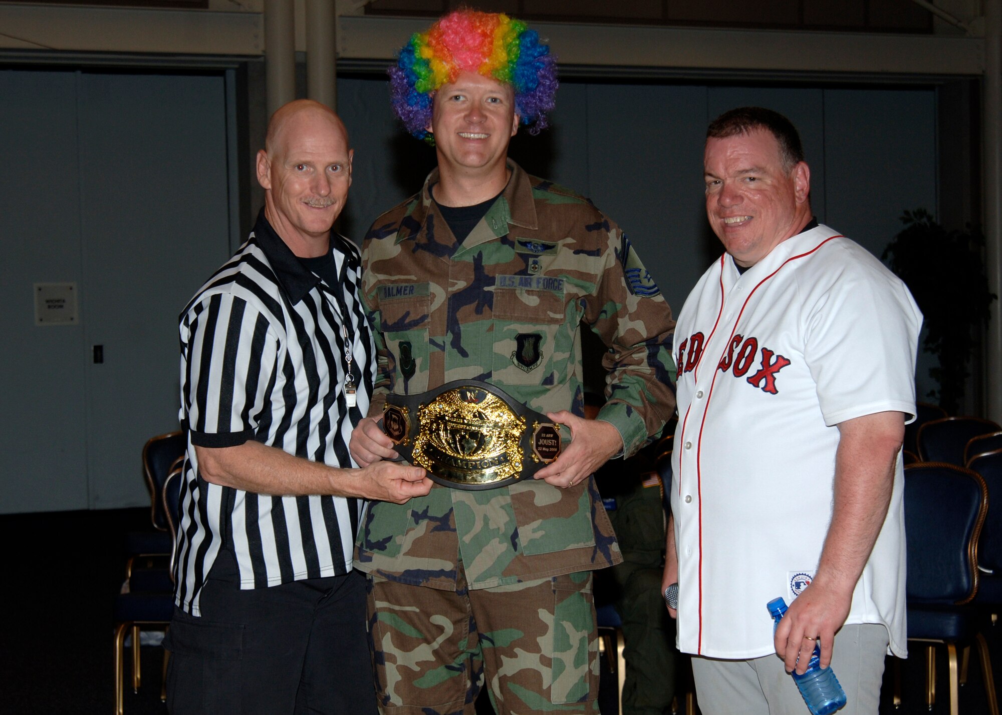 MCCONNELL AIR FORCE BASE, Kan. -- Master Sgt. Dan Bryant, 22nd Security Forces Squadron, and Senior Master Sgt. Ray Pelletier, 22nd Operations Support Squadron, present Senior Master Sgt. John Balmer, 22nd Medical Group, with champion’s belt during a wing joust tournament, at the Robert J. Dole Center ballroom, May 22. The jousting competitors from different base organizations dressed up in costumes and battled for first place and bragging rights. (Photo by Airman Justin Shelton)