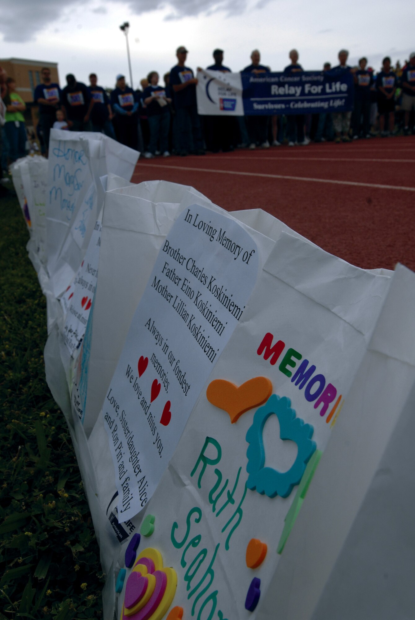 Unlit luminaries mark the memories of cancer victims, while survivors prepare to walk in the background at the Relay for Life, May 16 in San Angelo. (U.S. Air Force photo by Master Sgt. Randy Mallard)
