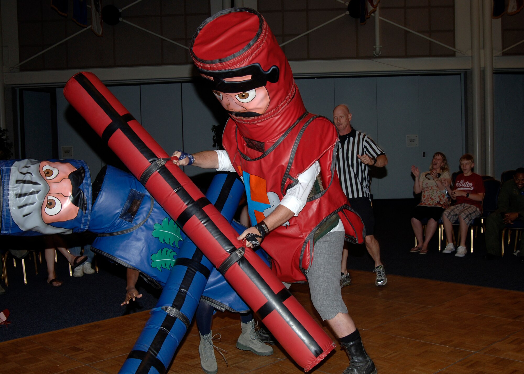 MCCONNELL AIR FORCE BASE, Kan. -- First Lt. Nicholas Gronlund, 22nd Communications Squadron, pummels Senior Airman April Robinson, 22nd Air Refueling Wing, during a joust tournament at the Robert J. Dole Center ballroom, May 22. Airman Robinson, dressed as an action hero while she represented McConnell’s Airman’s Council, while Lieutenant Gronlund dressed as pirate and jousted on behalf of McConnell’s Company Grade Officers. The lieutenant won the match, 3-2.  (Photo by Airman Justin Shelton)