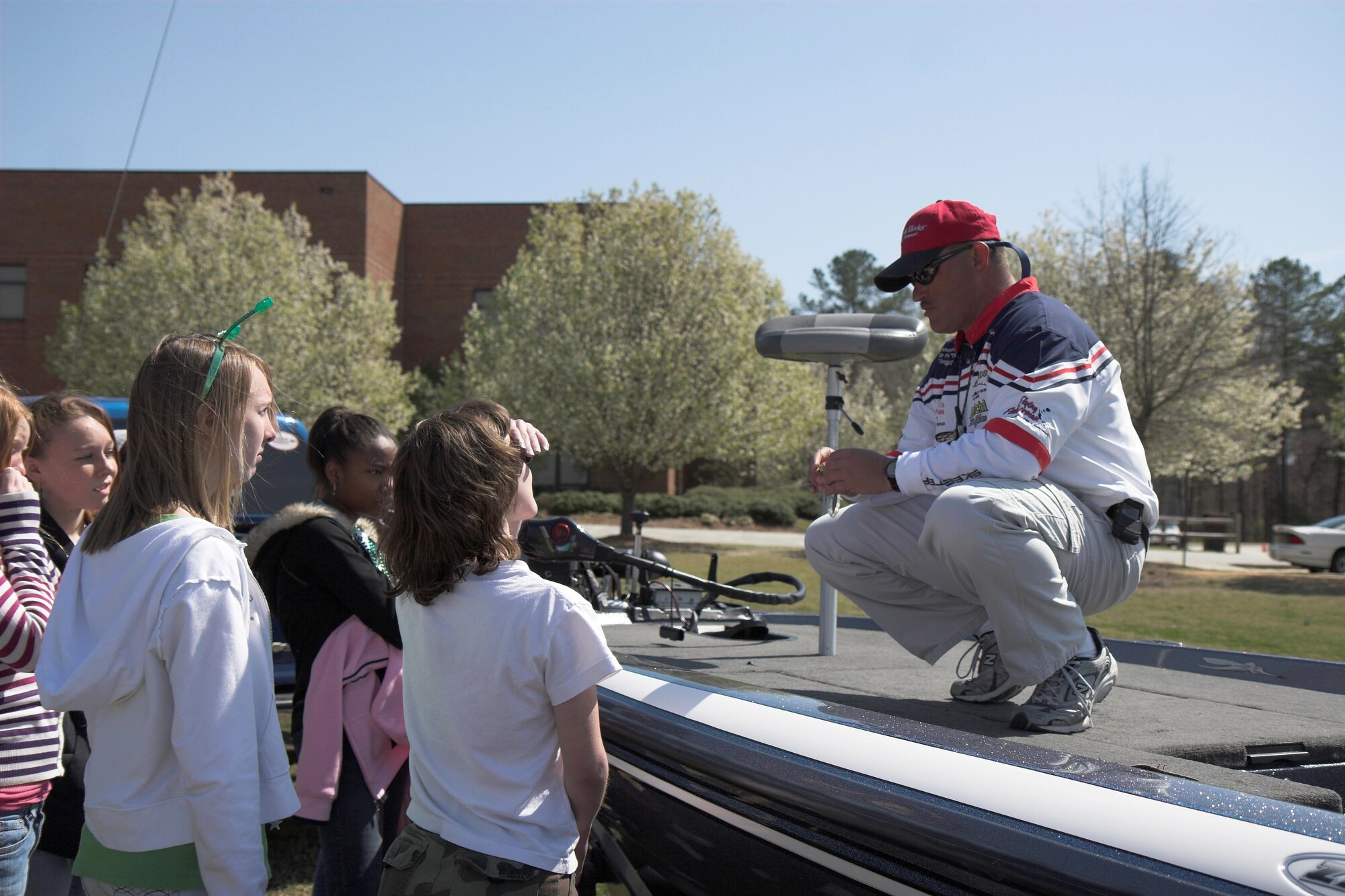 Tech. Sgt. James Poirrier, 743rd Aircraft Maintenance Squadron, talks to students at Harnett Central Middle School about fishing. Sergeant Poirrier, an amateur angler, spoke to more than 1,100 students and spent three days fishing with the students families at Lake Rim in Fayetteville. (U.S. Air Force Photo)