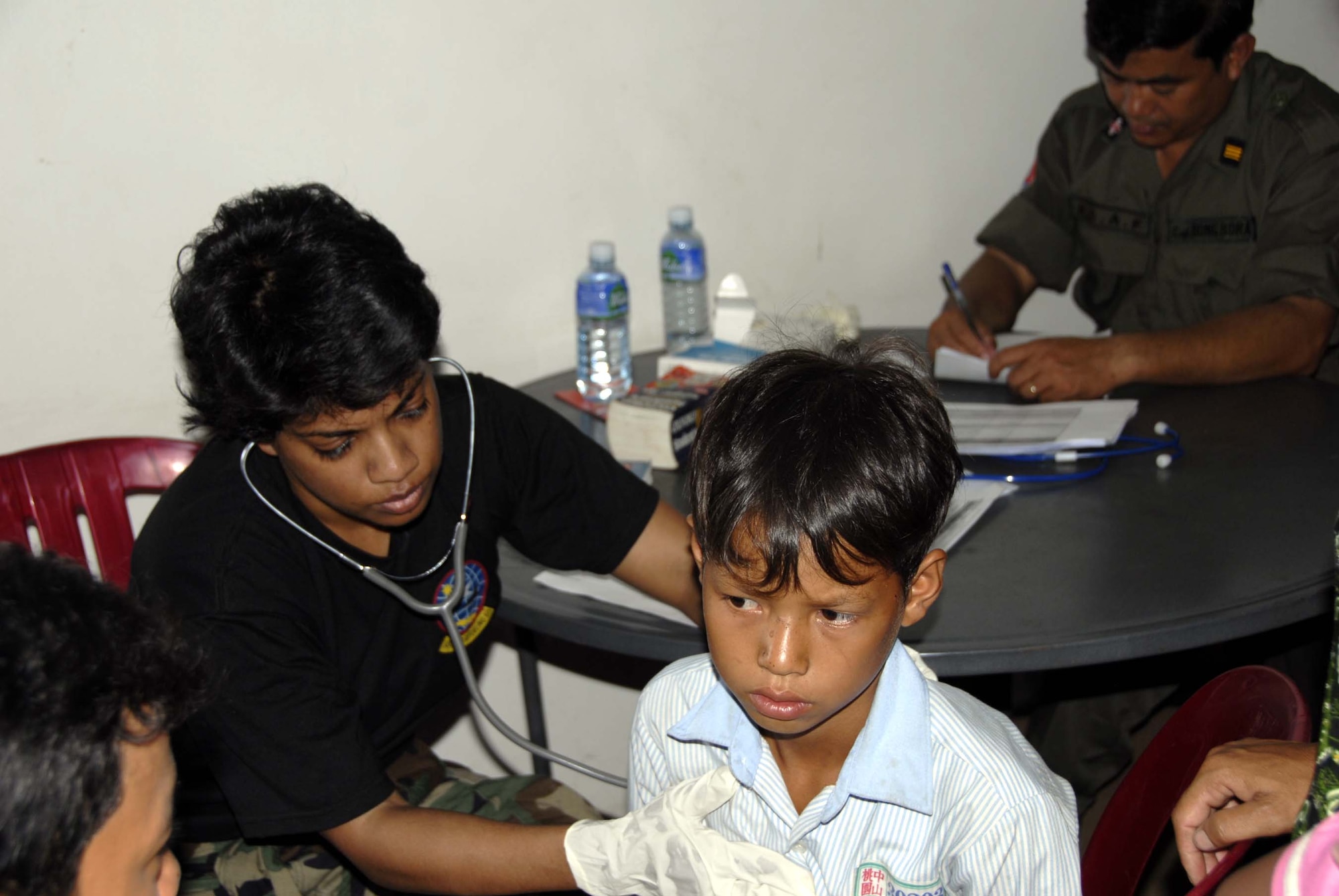 KAMPONG CHHNANG PROVINCE, Cambodia – A young Cambodian boy is being checked out for complaints of breathing trouble by Major Nisha Money, a preventive health physician from the Uniformed Services University of Health Sciences, Andrews AFB.  A 13th Air Force led total force team of Active Duty, Reserve and National Guard members are working with doctors from the Royal Cambodian Armed Forces, Cambodian dental students and other non-governmental organizations during Pacific Angel 08 May 25 – 29 to provide cost free medical care to the people of Cambodia at three different operating locations. Operation Pacific Angel is a joint/combined multi-national humanitarian assistance operation conducted in the Pacific area of responsibility in support USCDRPACOM capacity-building efforts.  Participating services include the Active, Reserve and National Guard components of the U.S. Air Force, U.S. Army, Royal Thai Air Force (RTAF), and Royal Cambodian Armed Forces (RCAF). (U.S. Air Force photo/Tech. Sgt. Tom Czerwinski)