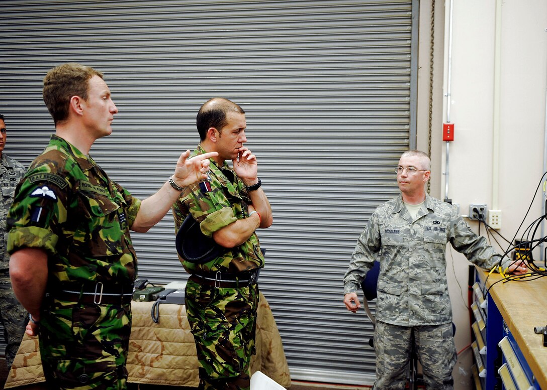 Master Sgt. Thomas McManus briefs two regiment officers from Great Britain's Royal Air Force here May 20. Sergeant McManus explains the different techniques the 820th SFG uses for communication in urban warfare. Sergeant McManus is assigned to the 824th Security Forces Squadron. (U.S. Air Force photo/Airman 1st Class Brittany Barker) 