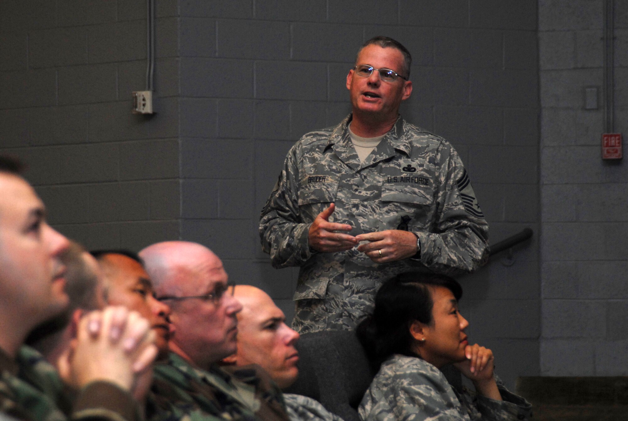 Chief Master Sgt. Bruce Broder, the Air Force Security Forces career field manager, talks to more than 150 security forces from Edwards, March Air Reserve Base and Los Angeles Air Force Base during Brig. Gen. Mary Kay Hertog's director's call at the base theater here May 27. General Hertog is the Air Force Security Forces director. (Air Force photo by Senior Airman Julius Delos Reyes)