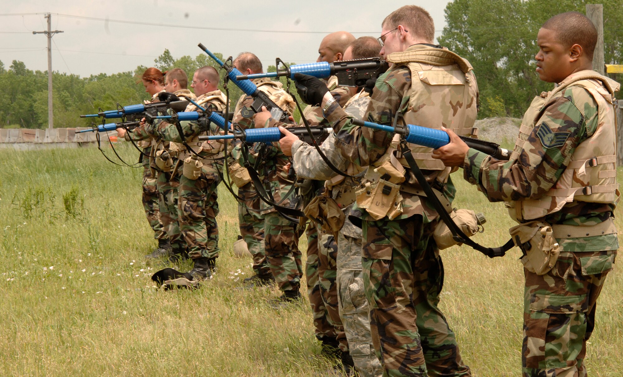 MCCONNELL AIR FORCE BASE, Kan. -- Combat skills training members of fire teams bravo, charlie, and delta, clear their weapons as a final precaution before ending their training at the base obstacle course, May 22. All of the trainees were provided with training M-16 rifles that fired simulated rounds consisting of plastic bullets with paint filled tips. (Photo by Airman Justin Shelton)