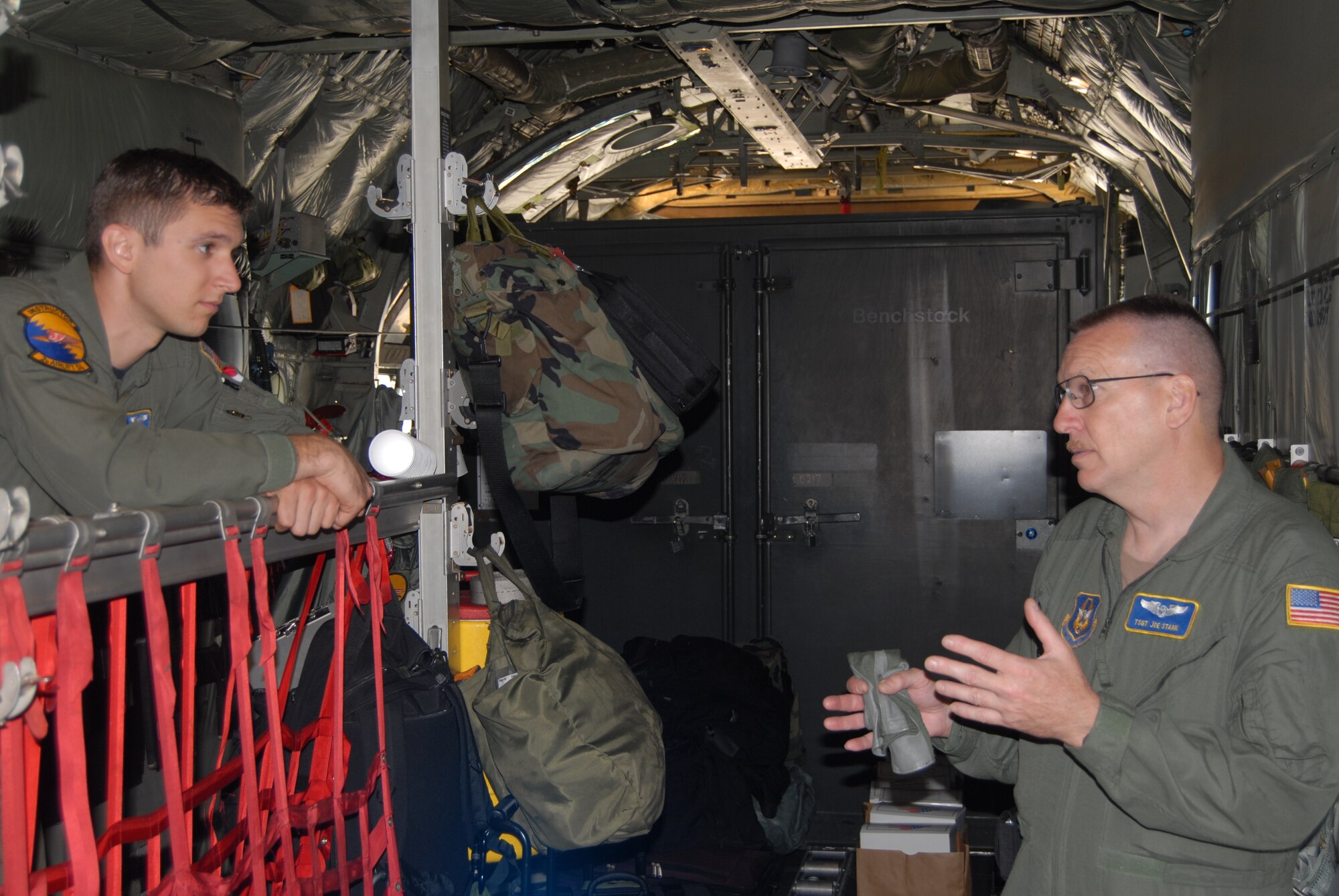 Staff Sgt. Josh Martin, 2nd Airlift Squadron flight engineer, talks with Tech. Sgt. Joseph Stark, 95th Airlift Squadron loadmaster, prior to departing Pope for Ramstein Air Base, Germany Sunday. This deployment is the first time that Airmen from the 2nd AS have deployed with Airmen from the 95th AS to the European and African theaters. The joint team will be gone for 16 days to provide logistical support to already deployed forces as well as emergency support for the shuttle during the next mission tomorrow, if need be. (U.S. Air Force Photo by Staff Sgt. jon LaDue)