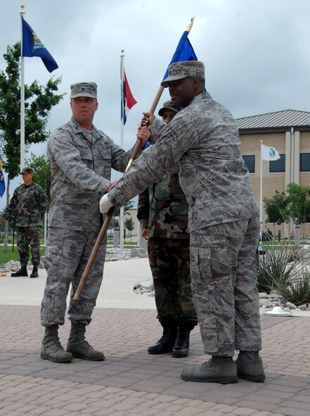 LAUGHLIN AIR FORCE BASE, Texas – Lt. Col. Garrick Williams, 47th Installation Support Squadron (Provisional) commander, receives the new 47th ISS(P) guidon at the 47th Civil Engineer Squadron and 47th Communications Squadron merger ceremony here May 27. (U.S. Air Force photo by Airman 1st Class Sara Csurilla)