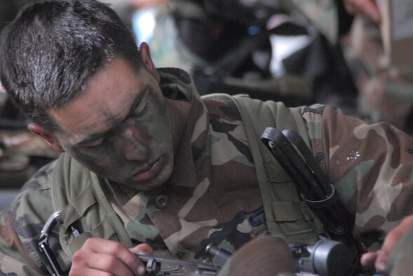 An airman cleans his weapon before using paint rounds (simulated ammunition) for their M-4s on the instructors posing as the enemy combatants during their immediate action drills while at the Combat Control School at Pope Air Force Base, N.C. These drills provide a foundation for muscle memory so when the time comes the training will kick in providing split second reaction to the situation. (U.S. Air Force Photo by Airman 1st Class Mindy Bloem)
