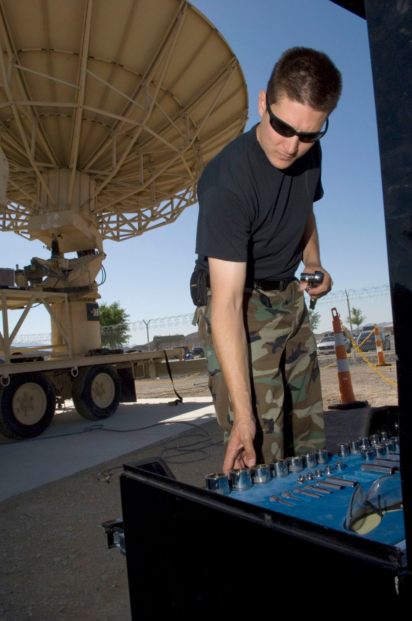 Technical Sgt. Chris Couture, a MQ-1 Predator communication supervisor assigned to the 232nd Operations Squadron, Nevada Air National Guard Las Vegas, Nev., selects the proper tools to work on the predator primary satellite link (PPSL) here May 19, 2008. The predator primary satellite link, is the focal point of communication to the MQ-1 predator and the pilots manning the aircraft from the ground control station.
(U.S. Air Force Photo by/Senior Airman Larry E. Reid Jr.)