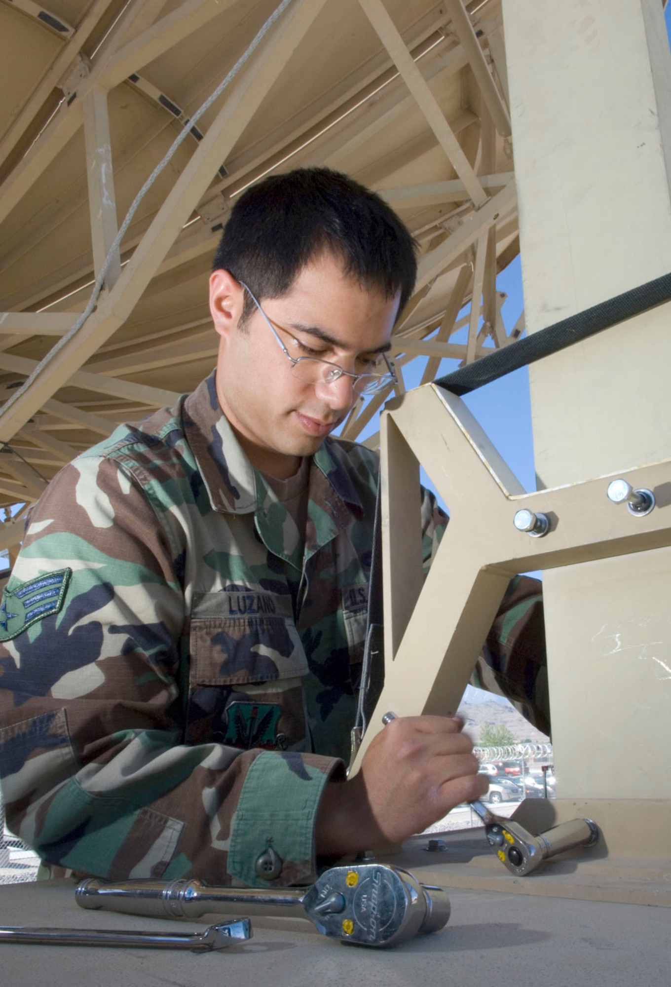 Senior Airman Dennis Luzano, a MQ-1 Predator communications specialist assigned to the 432nd Aircraft Maintenance Squadron, removes bolts on a flux gate compass to replace it with a more efficient one for antenna orientation on the predator primary satellite link (PPSL) here May 19, 2008. The predator primary satellite link is the focal point of communication to the MQ-1 predator and the pilots manning the aircraft from the ground control station.
(U.S. Air Force Photo by/Senior Airman Larry E. Reid Jr.)