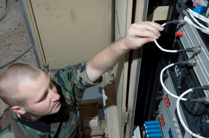 Airman 1st Class William Weaver, a MQ-1 Predator communications specialist assigned to the 432nd Aircraft Maintenance Squadron, identifies patching cables on the predator primary satellite link here May 19, 2008. The predator primary satellite link (PPSL), is the focal point of communication for the MQ-1 predator and the pilots manning the aircraft from the ground control station.
(U.S. Air Force Photo by/Senior Airman Larry E. Reid Jr.)