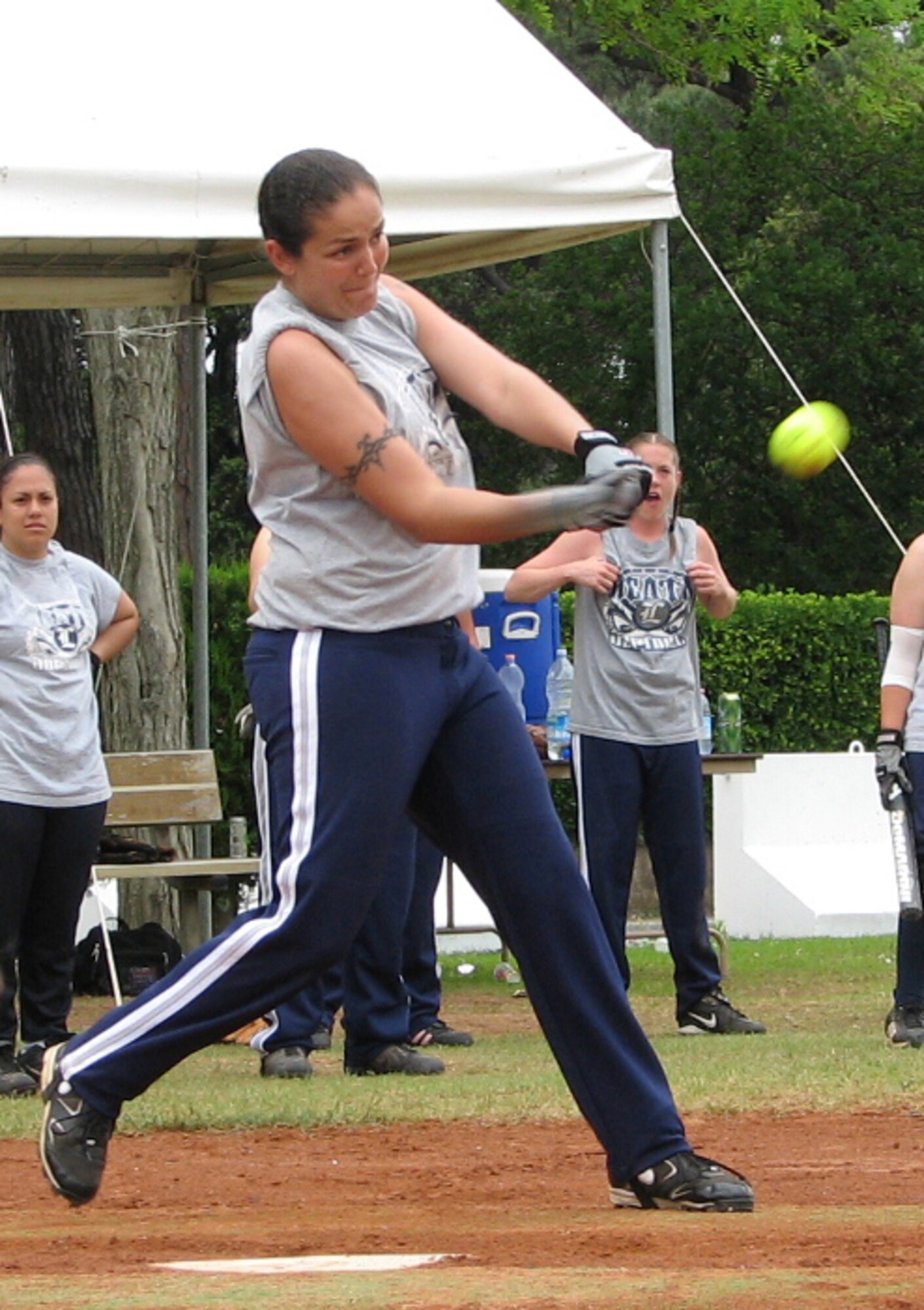 Danielle Hirvela, an outfielder on Lakenheath Women's Varsity softball team, swings at a pitch during a game against the Naval Air Station Sigonella Women's team at Camp Darby, Italy. The Lakenheath team lost to the SIgonella team during the Camp Darby's European Open Softball tournament.  The women’s team took fourth place and the Lakenheath Men's Varsity team took fifth place in the tournament. (U.S. Air Force photo by Tech. Sgt. Jason Gagnon) 
