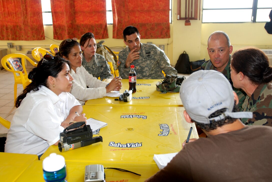 US Army Soldiers and Honduran media listen as Beyond the Horizons medical Navy Commander Michelle Dunsmore (right)of the Operational Health Support Unit provides information on their efforts to provide medical, dental, and vetrinary assistance to remote communities. Photo taken on May 03, 2008 in Puerta Castilla, Honduras. On April 28th through May 6th, Honduran and U.S. Navy medical service members visit the towns of Rio Platano, Las Marias, Pimienta, Yapuwas and Wawina to provide medical services to all interested citizens in those locales. (Photo by First Lieutenant Ryan Hanna)(Released)