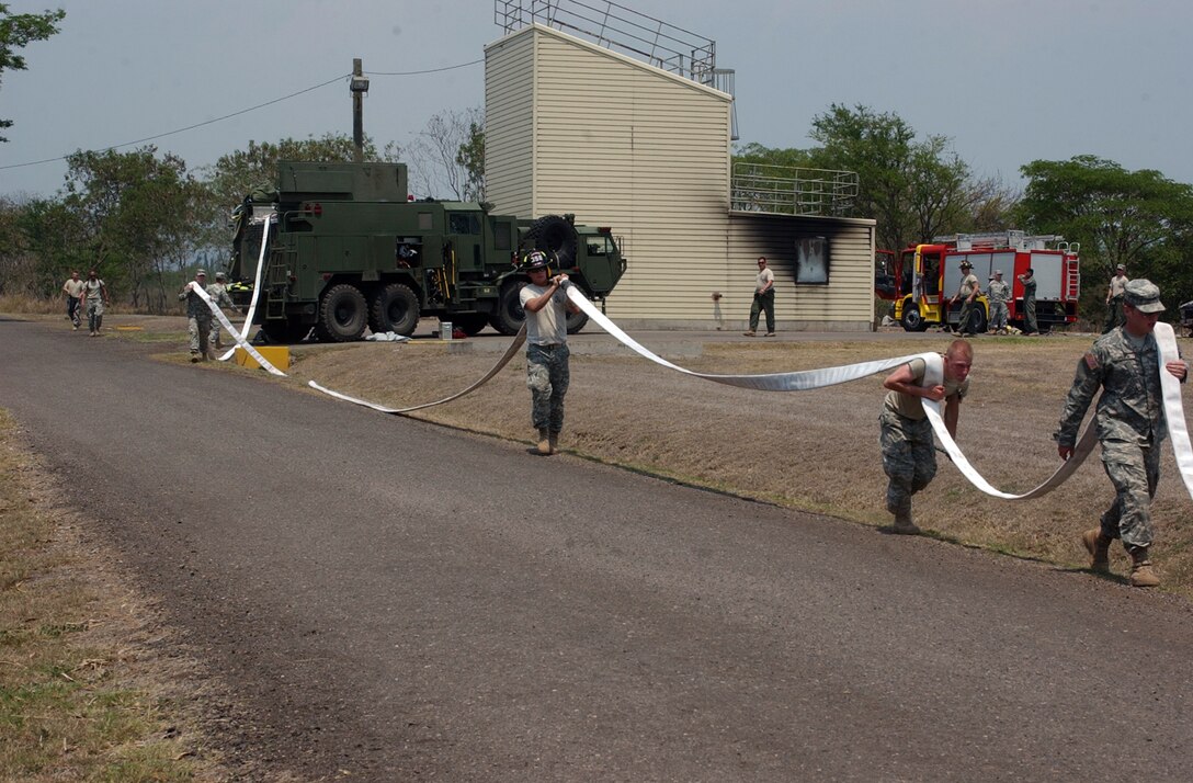 Soldiers from the 287 Engineer Detachment Fire Fighters and 356 Engineer Detachment Fire fighters out of Danvers, Massachusetts bring a fire hose to a hydrant during a training exercise held with the local fire department on Soto Cano Air Force Base, Honduras on May 01, 2008 during the training exercise Beyond the Horizons 2008.  Beyond the Horizons is a joint forces training exercise  between the United States and Honduras to foster goodwill and improve relations between the two nations. (Photo by SGT Kathy Jo Young)(Released)