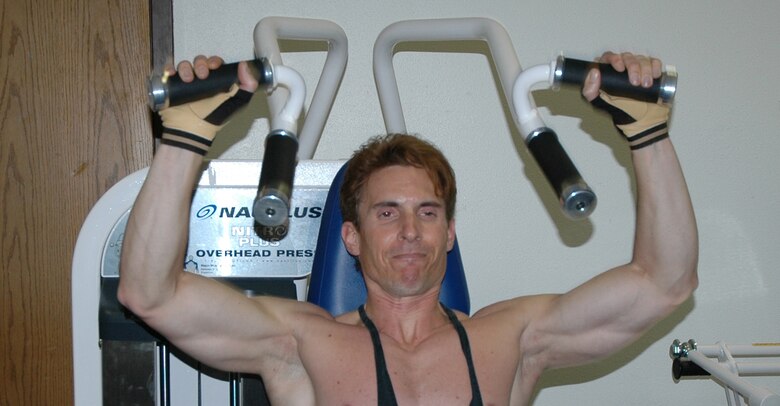 Eric Thayer works out his medial deltoid muscles on the equipment at the Sports and Fitness Center May 27. He weight trains three times a week to keep in shape and to help prepare him to take the Air Force physical training test each year. (U.S. Air Force photo/Valerie Mullett)