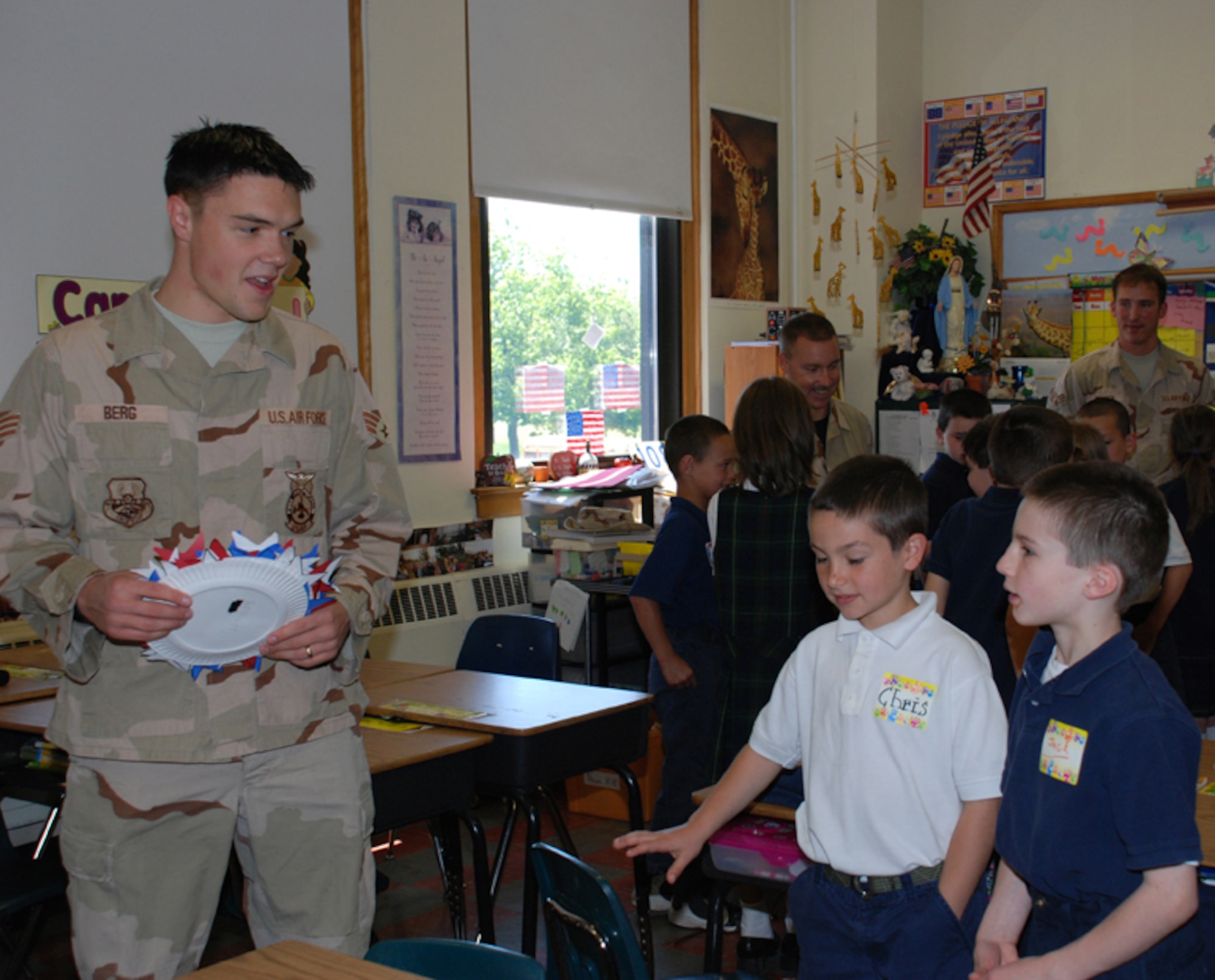 Senior Airman Jason Berg, 107th AW firefighter, talks to his pen pals, Chris and Jack, two second graders from St. Christophers elementary school who wrote to the airman while he was serving in Iraq.  Berg's pen pals presented him with patriotic artwork and thank you cards.