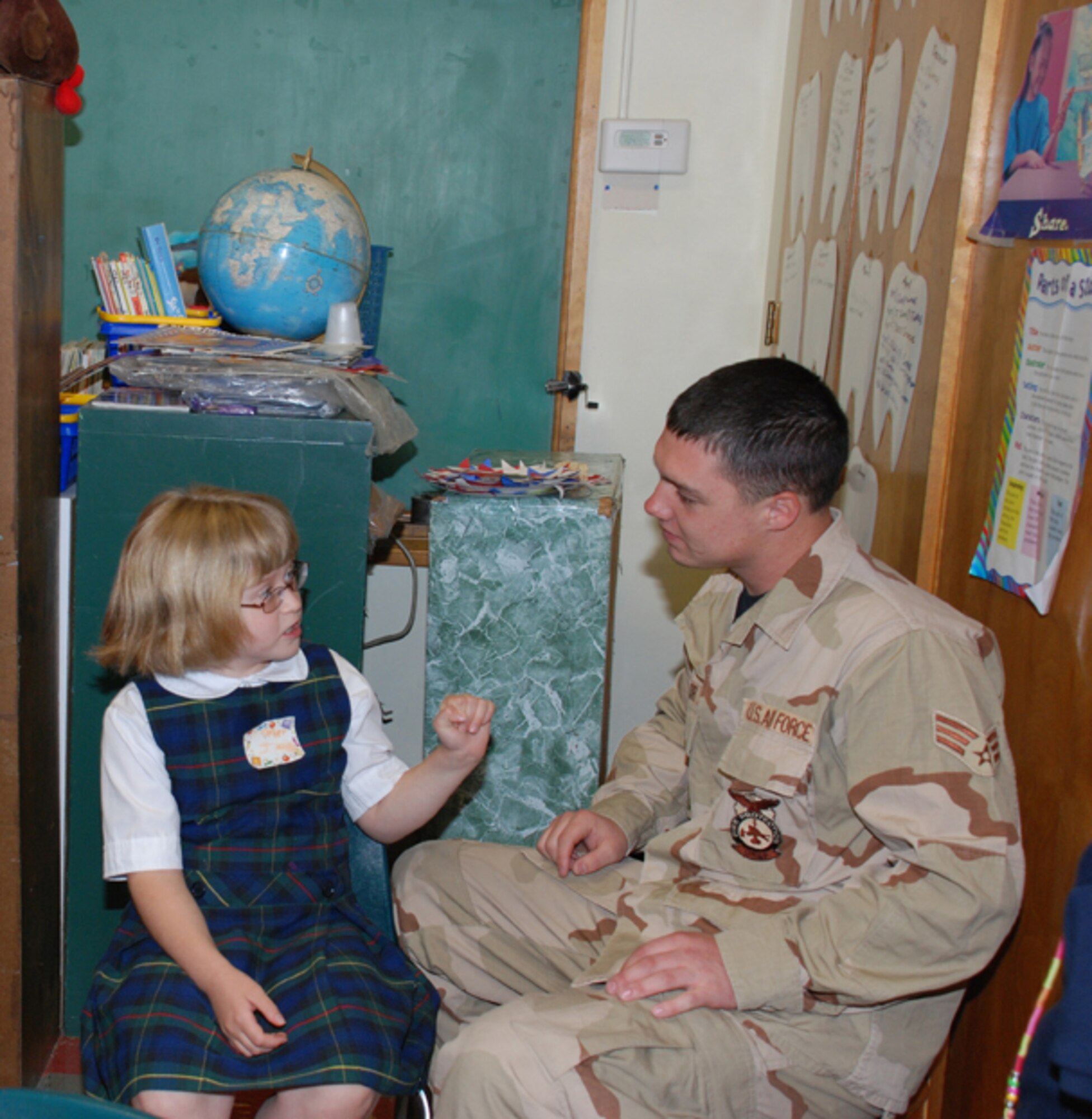 Senior Airman John Baylor, 107th AW firefighter, talks to one of his pen pals inside her second grade classroom.  Baylor corresponded with four students from St. Christophers Elementary School while he was serving in Iraq.