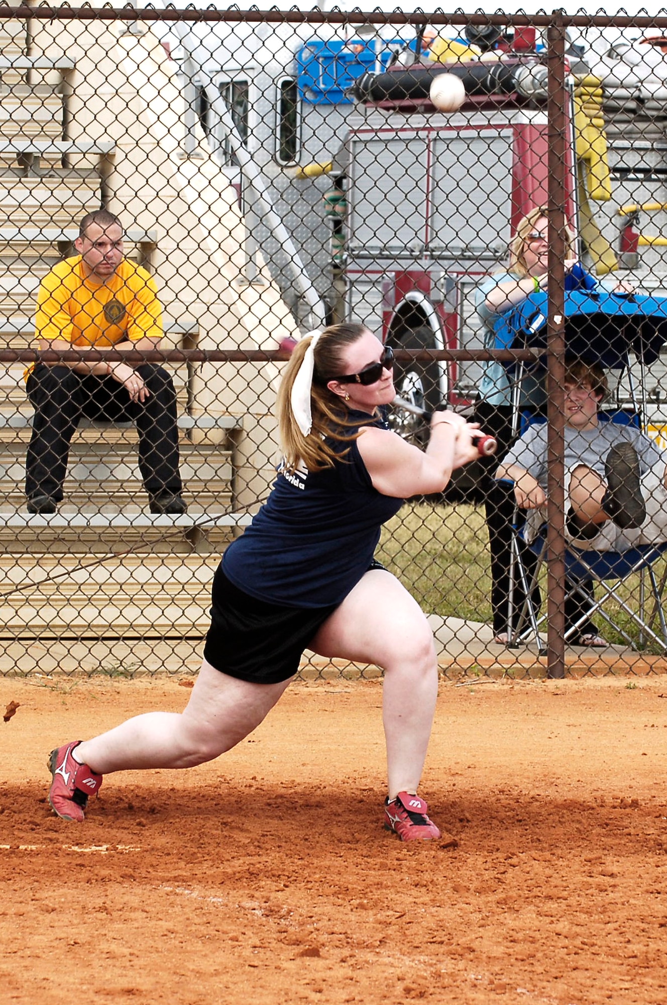 Danielle Bernt swings her bat at the ball during the softball game May 24. The tournament was held to help raise money to pay for her father's cancer treatment.(U.S. Air Force photoby Senior Airman Bradley) 