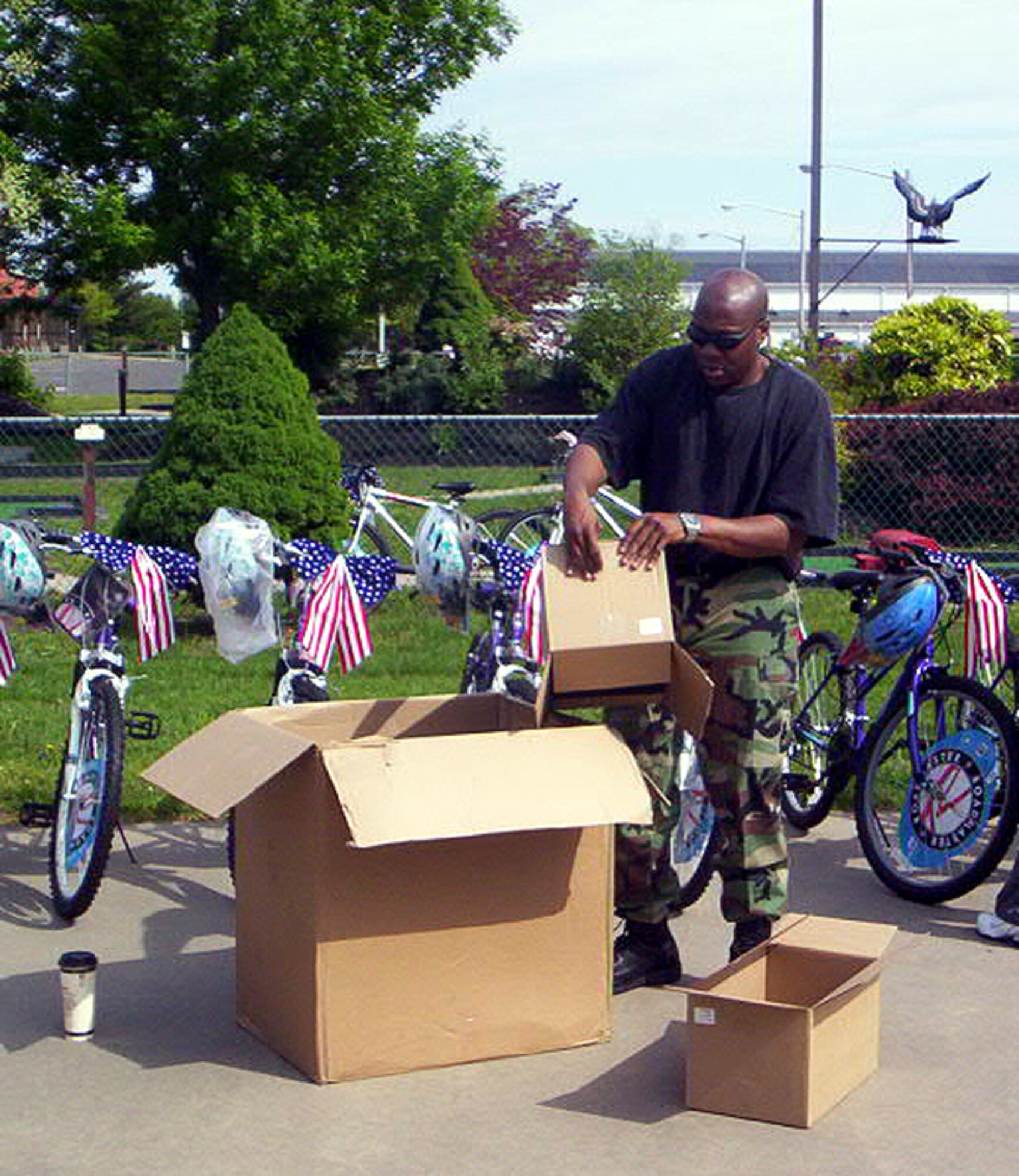 Tech. Sgt. Michael Davis, a McGuire 56 member, unpacks helmets during the third annual BAE Systems’ bicycle donations for children from McGuire, Fort Dix and Lakehurst  communities recently here. McGuire 56 members helped present more than 130 bicycles, with helmets, to the children. (U.S. Air Force courtesy photo)   