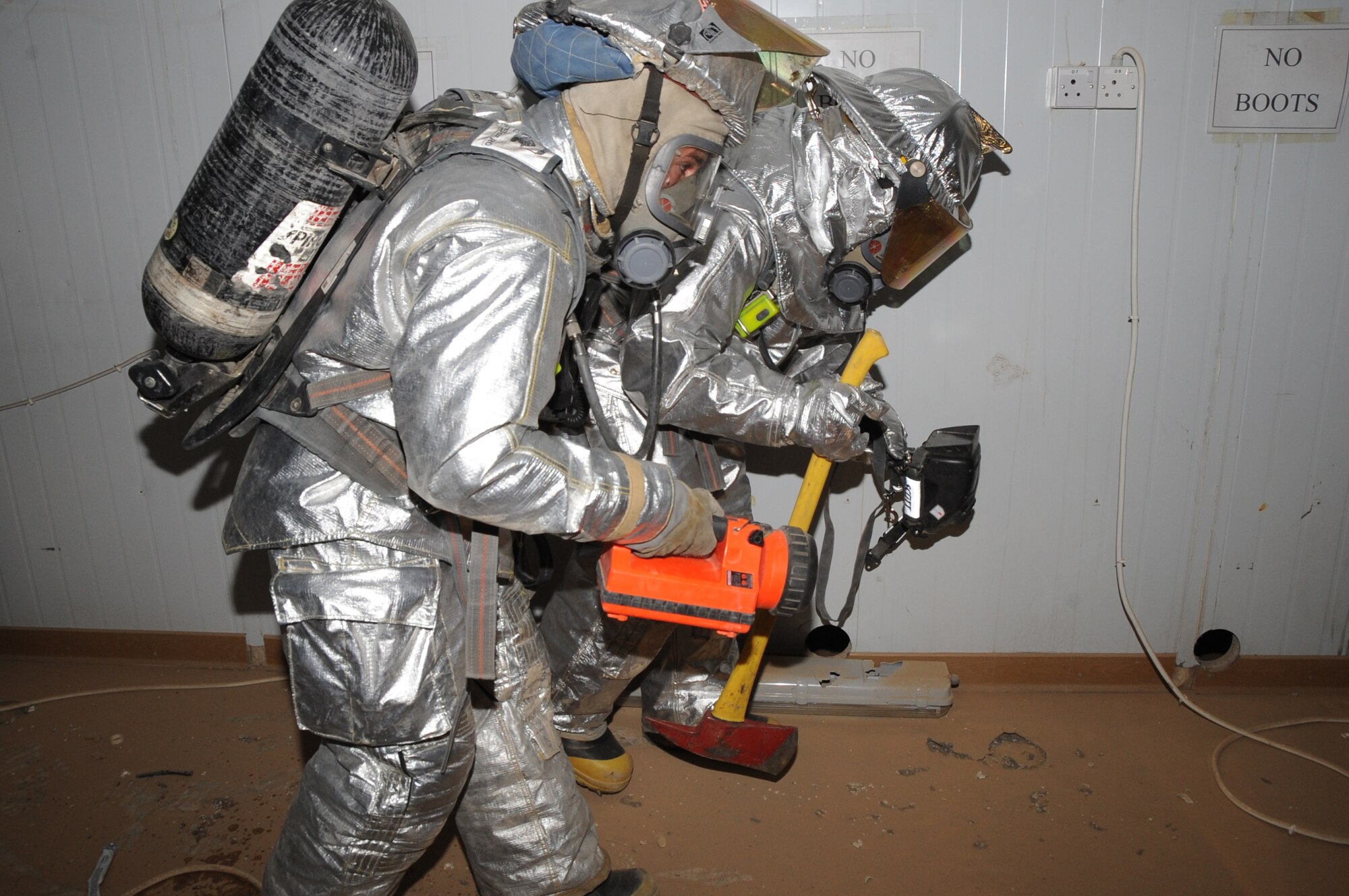 ALI BASE, Iraq -- Tech. Sgt. Richard Matteson and Staff Sgt. Scott Herbert, 407th Expeditionary Civil Engineer Squadron firefighters, use a thermal imager and flashlight to search for victims during a simulated structural emergency exercise here May 28. Air Force firefighters train to improve skills and knowledge in the case of an incident on Contingency Operating Base Adder and Ali Base. Sergeant Matteson is deployed from Eielson AFB, Alaska and Sergeant Herbert is deployed from Ellsworth AFB, S.D. (U.S. Air Force photo/Tech. Sgt. Sabrina Johnson)