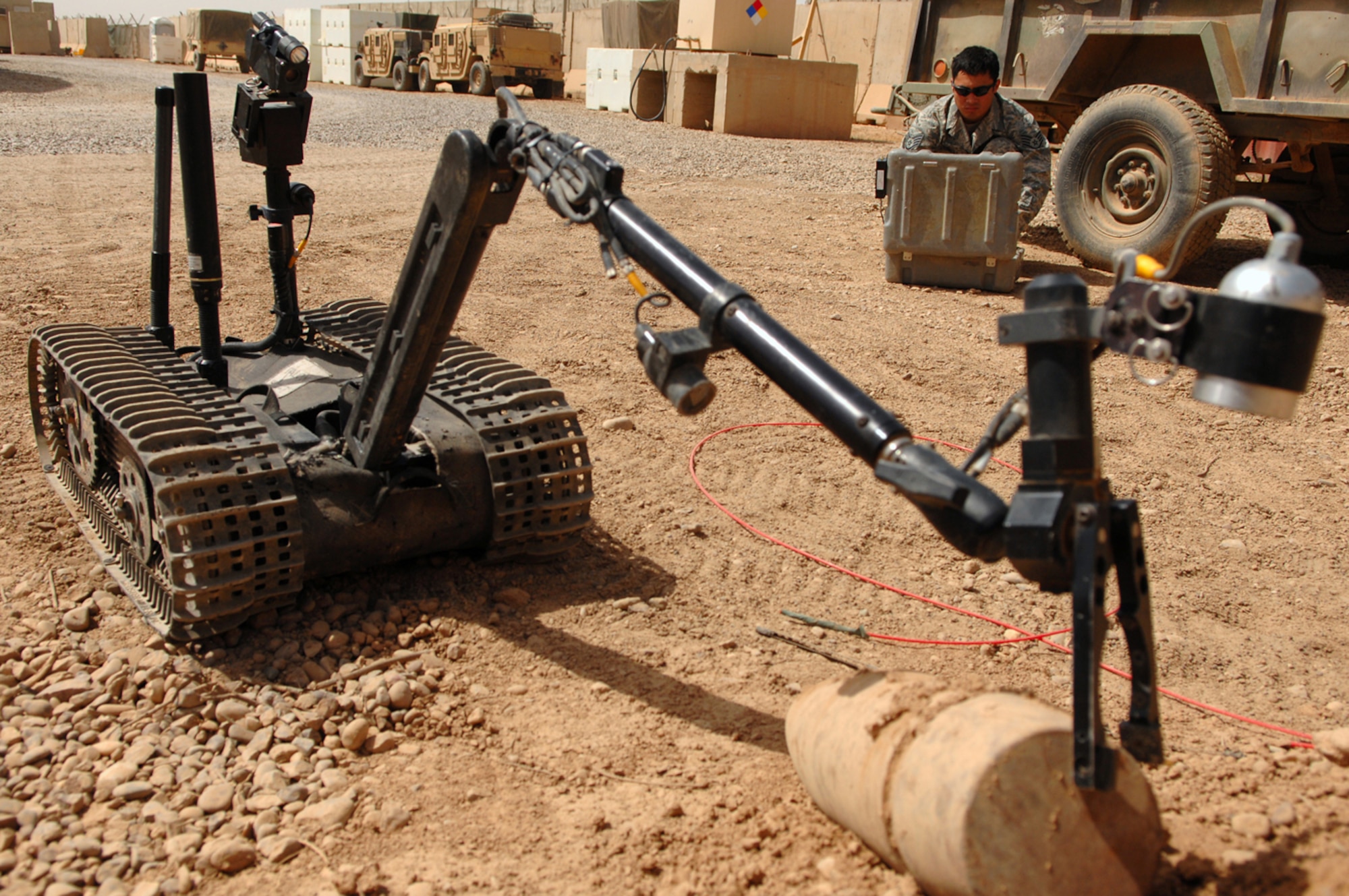 BALAD AIR BASE, Iraq -- Staff Sgt. Christopher Ferrell, 332nd Expeditionary Civil Engineer Squadron explosive ordnance disposal flight noncommissioned officer, tests the operability of a Talon robot by manipulating a disarmed improvised explosive device here, May 26. The robot is used to disarm unexploded ordnances up to 1,000 meters away from the robot operator. EOD Airmen respond to UXO findings within the confines of Balad AB and also participate in convoy operations with U.S. Army Soldiers identifying and disabling roadside improvised explosive devices that endanger the lives of traveling coalition forces and Iraqi civilians. Robot operators must work quickly and carefully without letting stress affect their performance. Sergeant Ferrell is deployed from Charleston Air Force Base, S.C. (U.S. Air Force photo/ Senior Airman Julianne Showalter) 