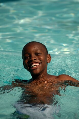 Maliki Fleming relaxes in the base pool May 26. Maliki, 8, is the son of retired Air Force member Delbert Fleming. (U.S. Air Force photo/Senior Airman Nicholas Pilch)