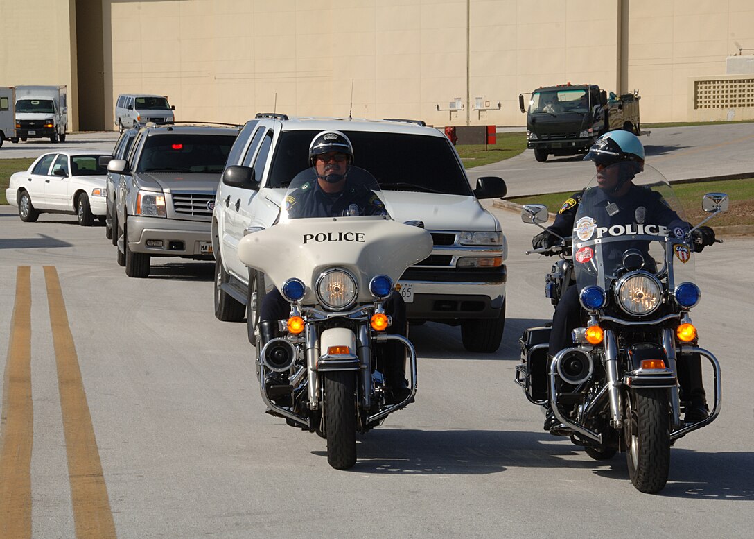 The Motorcade advances to meet The Secretary Of Defense, Dr. Robert Gates at the end of the red carpet as he arrives at Andersen Air Force Base on May 29. This is Dr. Robert Gates first visit to Andersen AFB as the Secretary Of Defense. (U.S. Air Force by Airman 1st Class Courtney Witt)   