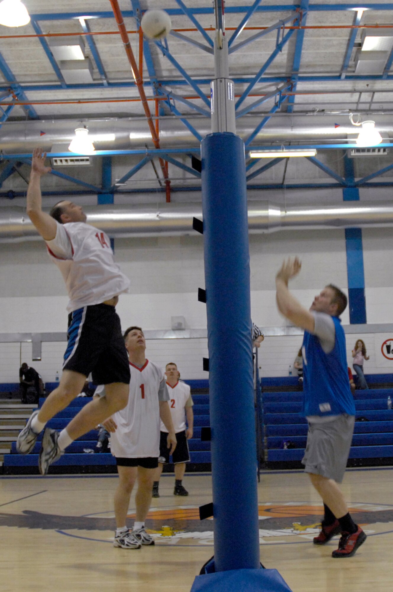 Airman 1st Class Matthew Long 48th Comptroller Squadron, attempts to block a spike from Tech. Sgt. Mark Willcutt, 48th Equipment Maintenance Squadron, May 21 at RAF Lakenheath, England. The two squadrons played in a double-elimination playoff tournament with CPTS advancing in the winners' bracket and EMS trying to stay alive in the losers' bracket with one loss. (U.S. Air Force photo by Airman Perry Aston)