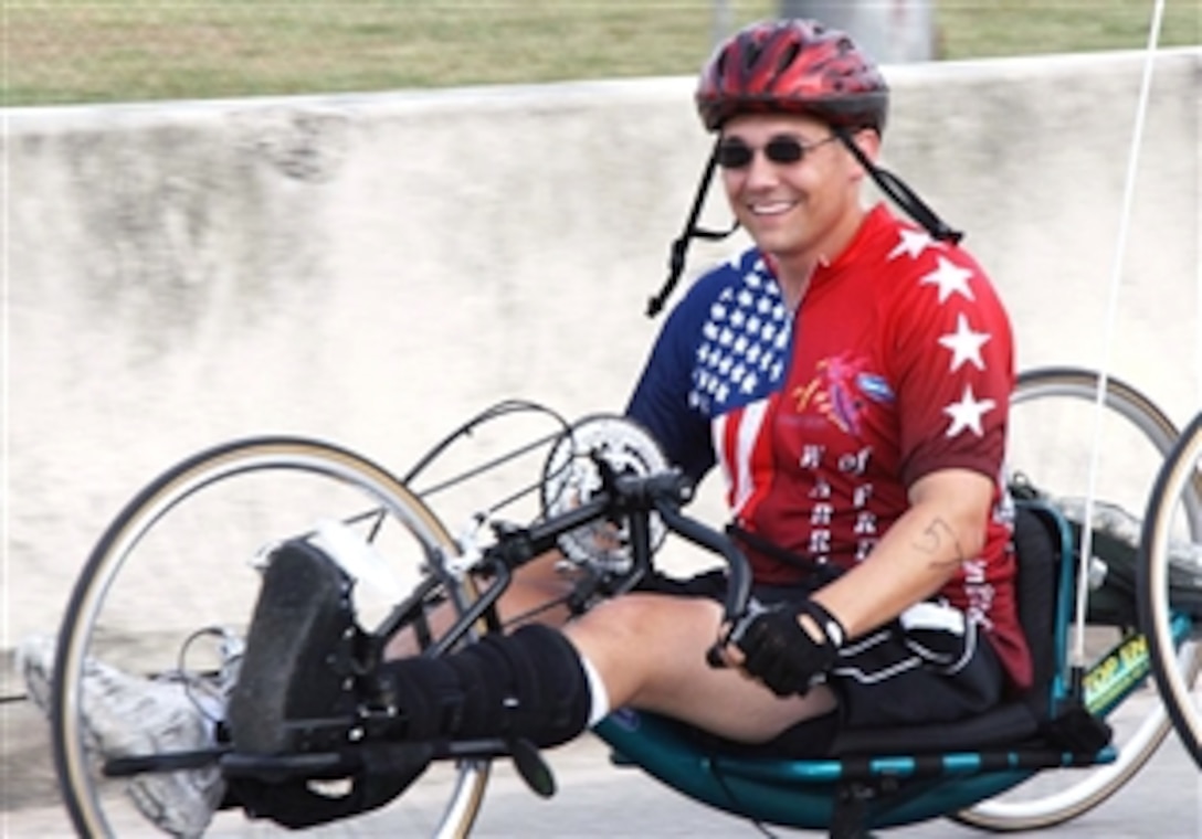 U.S. Army Cpl. Terry Lingman uses a hand cycle to complete a 10-mile bike ride during a triathlon for wounded warriors on Fort Sam Houston, Texas, May 23, 2008. The Center for the Intrepid in San Antonio sponsored the event, and Operation Comfort and the City of San Antonio  donated hand cycles.