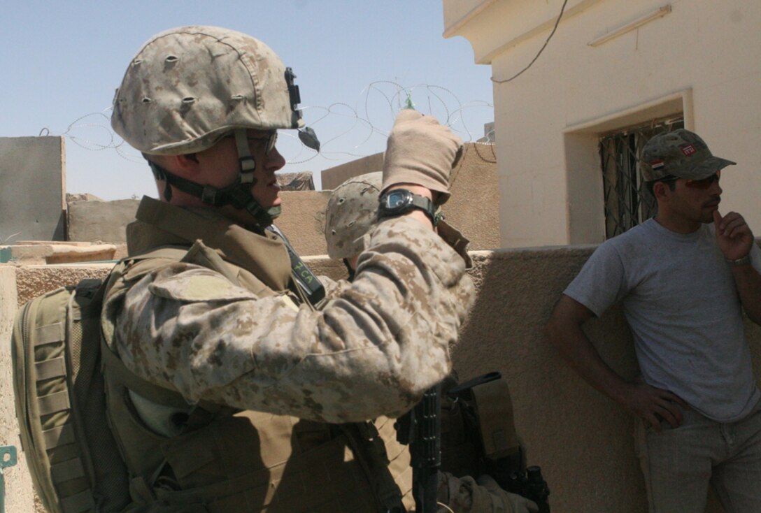 Petty Officer 3rd class Justen C. Adams, a corpsman with Detachment 1, Civil Affairs Team 5, 2nd Battalion, 11th Marine Regiment, Regimental Combat Team 5, takes pictures of the damage to the outside of the post office in Rawah, Iraq, May 29. CA Team 5 did a project assessment to determine what repairs need to be done to make the post office functional again. The compound with the post office also includes a phone center which, once the facilities are updated, will provide the city with constant phone service. The contract was signed June 19 and the project is expected to be finished sometime in August.::r::::n::
