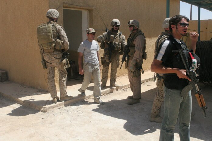 Marines with Detachment 1, Civil Affairs Team 5, 2nd Battalion, 11th Marine Regiment, Regimental Combat Team 5, in Rawah, Iraq, evaluate the working conditions of the post office May 29. CA Team 5 conducted a project assessment on repairs and improvements that need to be done to compound that held a post office and phone center. The compound was previously used by Coalition forces and Iraqi Police as a post, but will again be the town's post office and phone center.::r::::n::