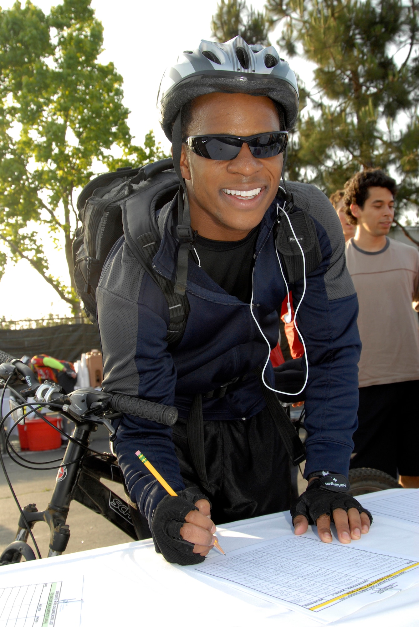 Lt. Ryan Vincent Downing, Milsatcom Wing, signs in after riding his bike to work, May 13. Personnel from Los Angeles AFB, The Aerospace Corporation and other local companies took the challenge to ride their bikes to work including a group that rode more than 20 miles from Fort MacArthur. (Photo by Joe Juarez)