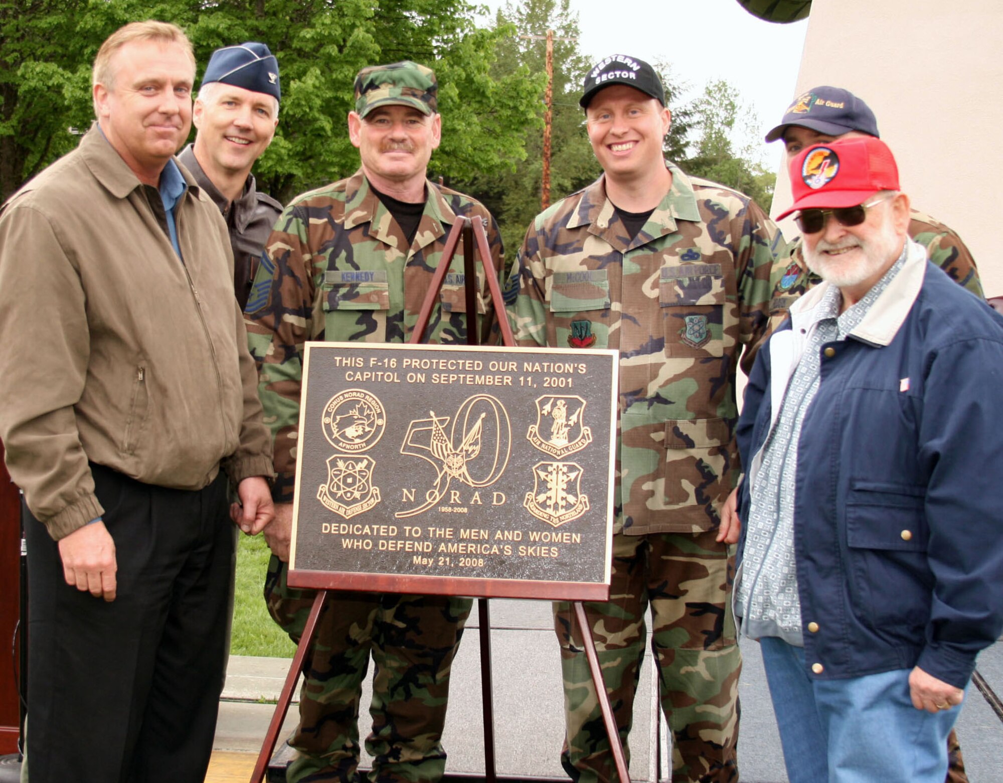 Joining Sector Commander Col. Paul Gruver, second from left, in unveiling the F-16 plaque were several key players in getting the aircraft ready for display. They are from left Mr. Greg Heidloff of WADS; Senior Master Sgt. John Kennedy from the 194th Operations Group; Master Sgt. Scott McCool of WADS; Master Sgt. James Roark (partially hidden) from Arizona's 162nd Fighter Wing, and Mr. Ken Roberts, representing McChord Air Museum. (U.S. Air Force photo/Randy Rubattino)