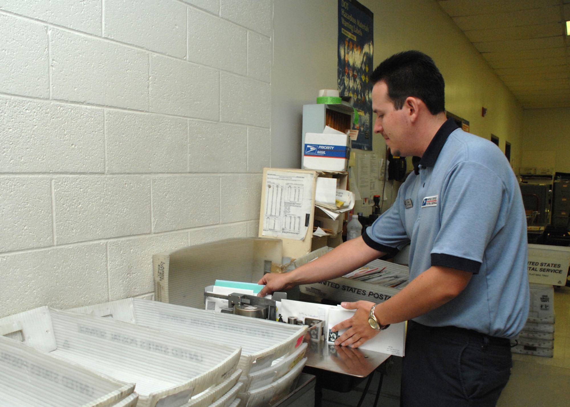 Sales Associate, John Filip of the Holloman Air Force Base Post Office cancels letters. Canceling letters marks the end of a letter's travel cycle and serves the purpose of postmarking letters and voiding the stamps.(U.S. Air Force photo/Senior Airman Tiffany Trojca)