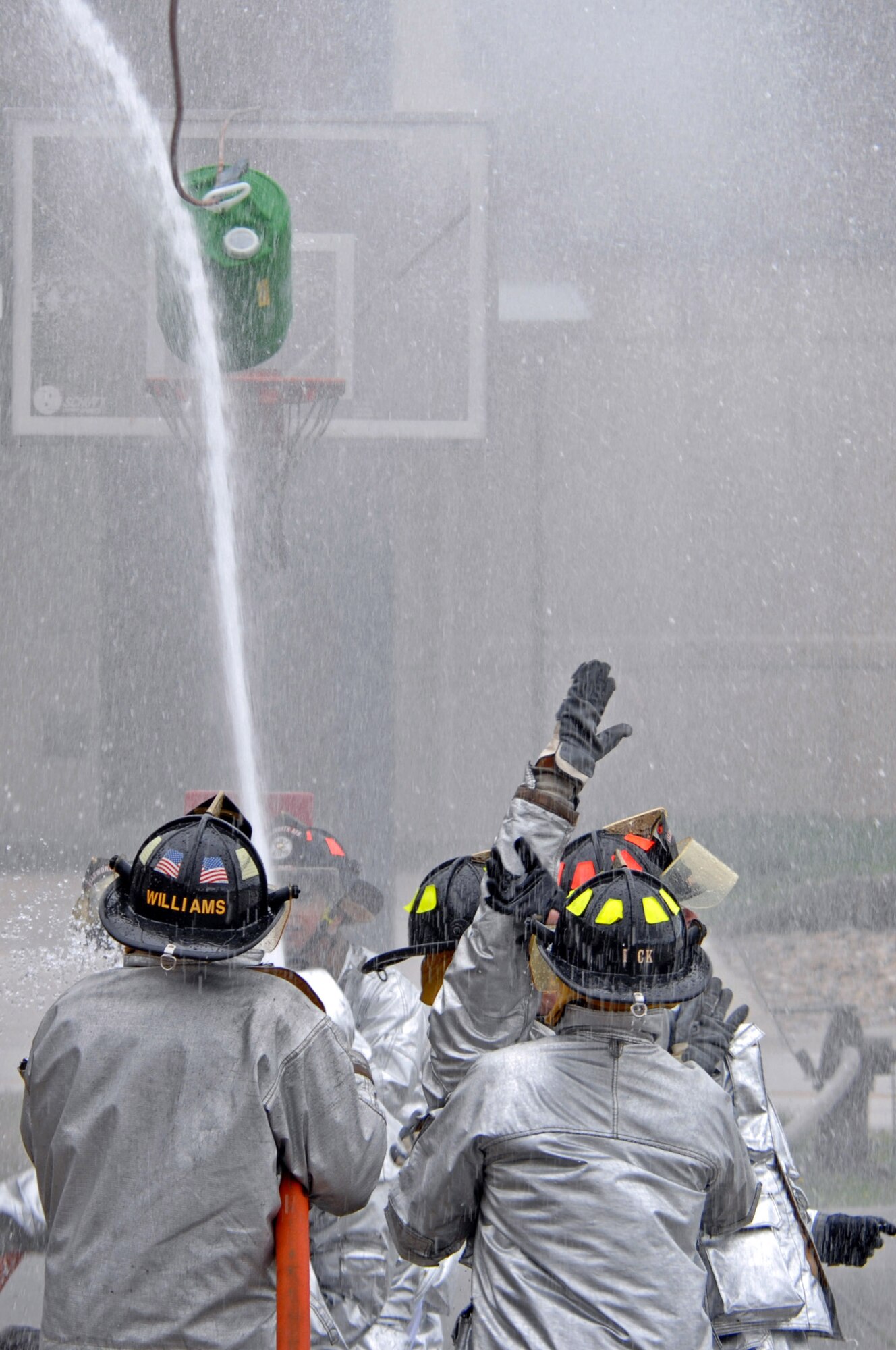 Ellsworth members competed during the water barrel spraying contest in the Firefighter Challenge. The afternoon event pitted the best eight teams who participated the earlier morning events. The challenge consisted of a ladder challenge amongst other challenges. (U.S. Air Force photo/Airman Corey Hook)