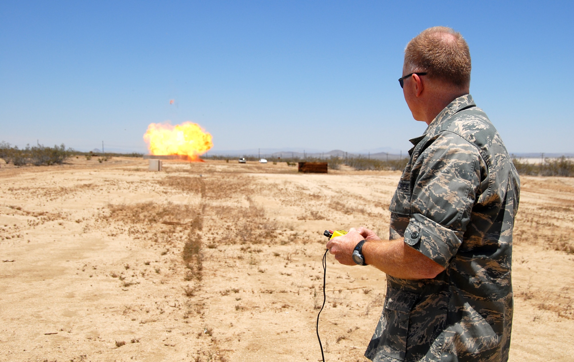 Col. Jerry Gandy, 95th Air Base Wing commander, conducts a controlled detonation at the Explosive Ordnance Division range here May 30 during his immersion with the 95th Civil Engineer and Transportation Directorate. Colonel Gandy took command of the 95th ABW May 16. (Air Force photo by Senior Airman Julius Delos Reyes)