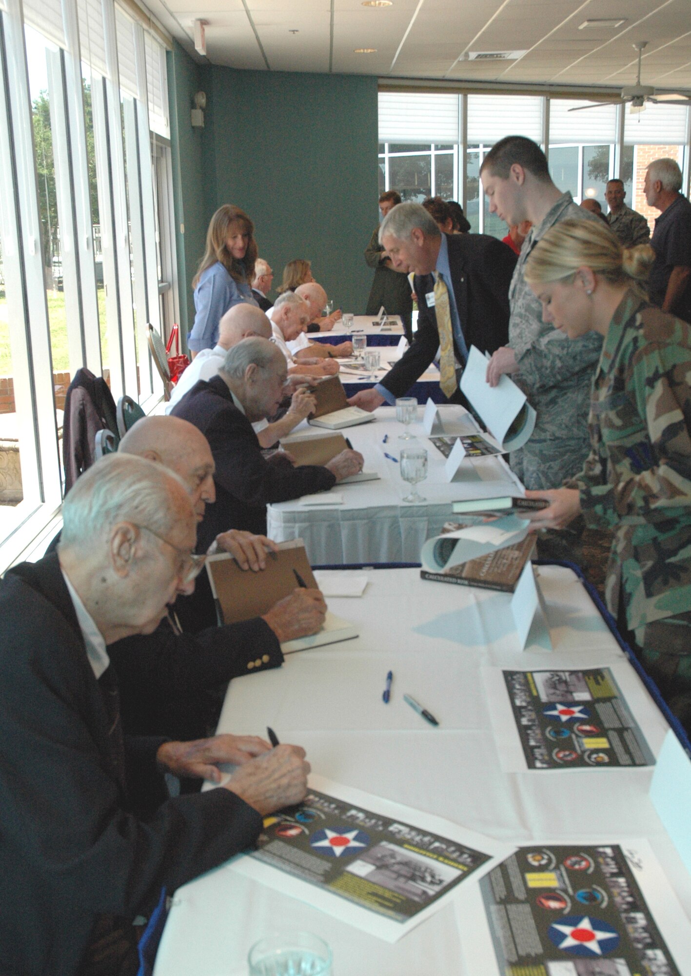 Six members of the Doolittle Raiders sign autographs at Eglin's Officer's Club May 28.