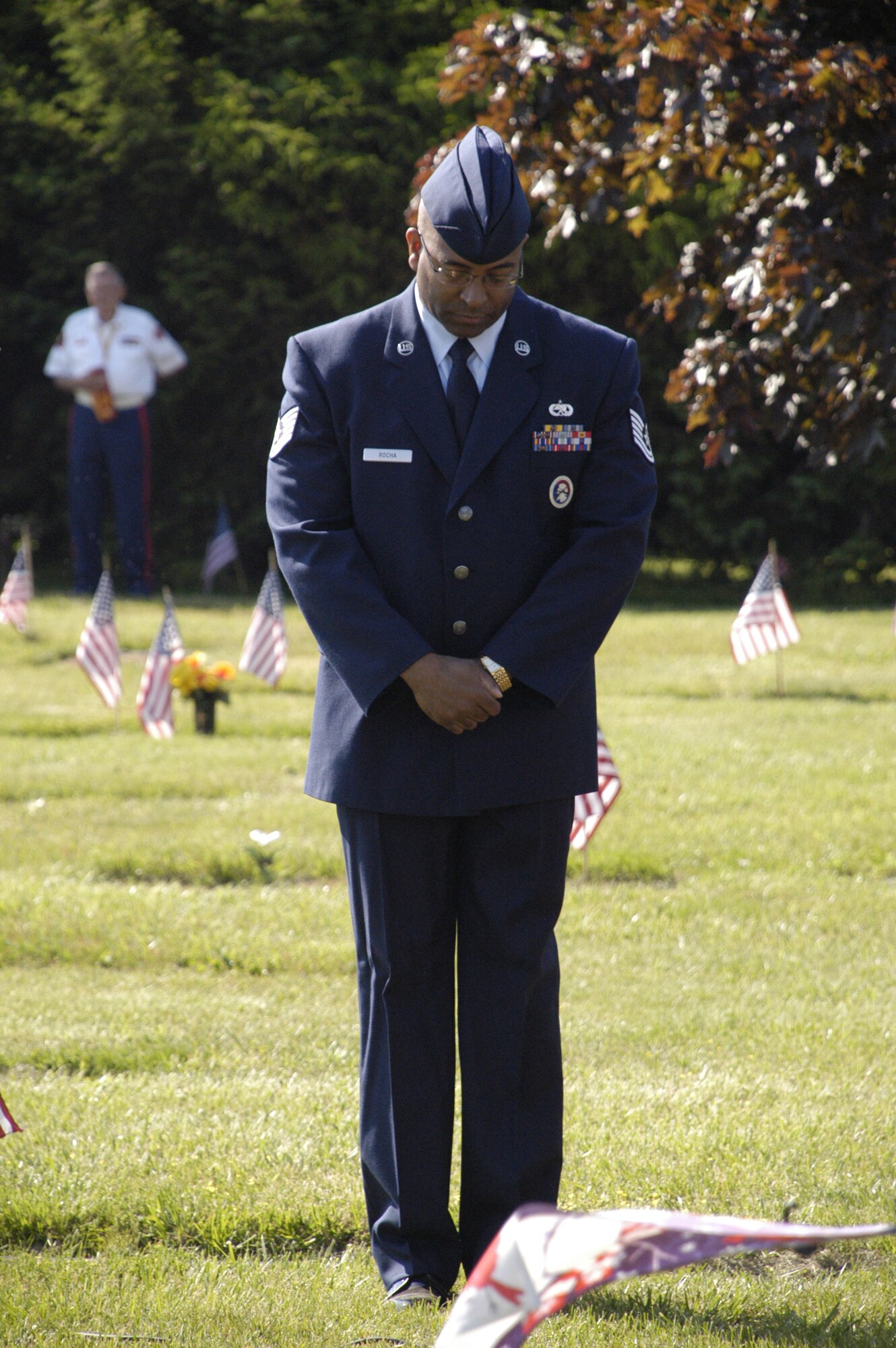 Tech. Sgt. Gerald Rocha, NCO in-charge of the Dover AFB Honor Guard, prays during the invocation for the annual Memorial Day service at Sharon Hills Memorial Park in Dover, Del. The Central Delaware Detachment of the Marine Corps League and the Dover Air Force Base Honor Guard paid homage more than 700 military veterans during the event. (U.S. Air Force photo/Airman 1st Class Shen-Chia Chu)
