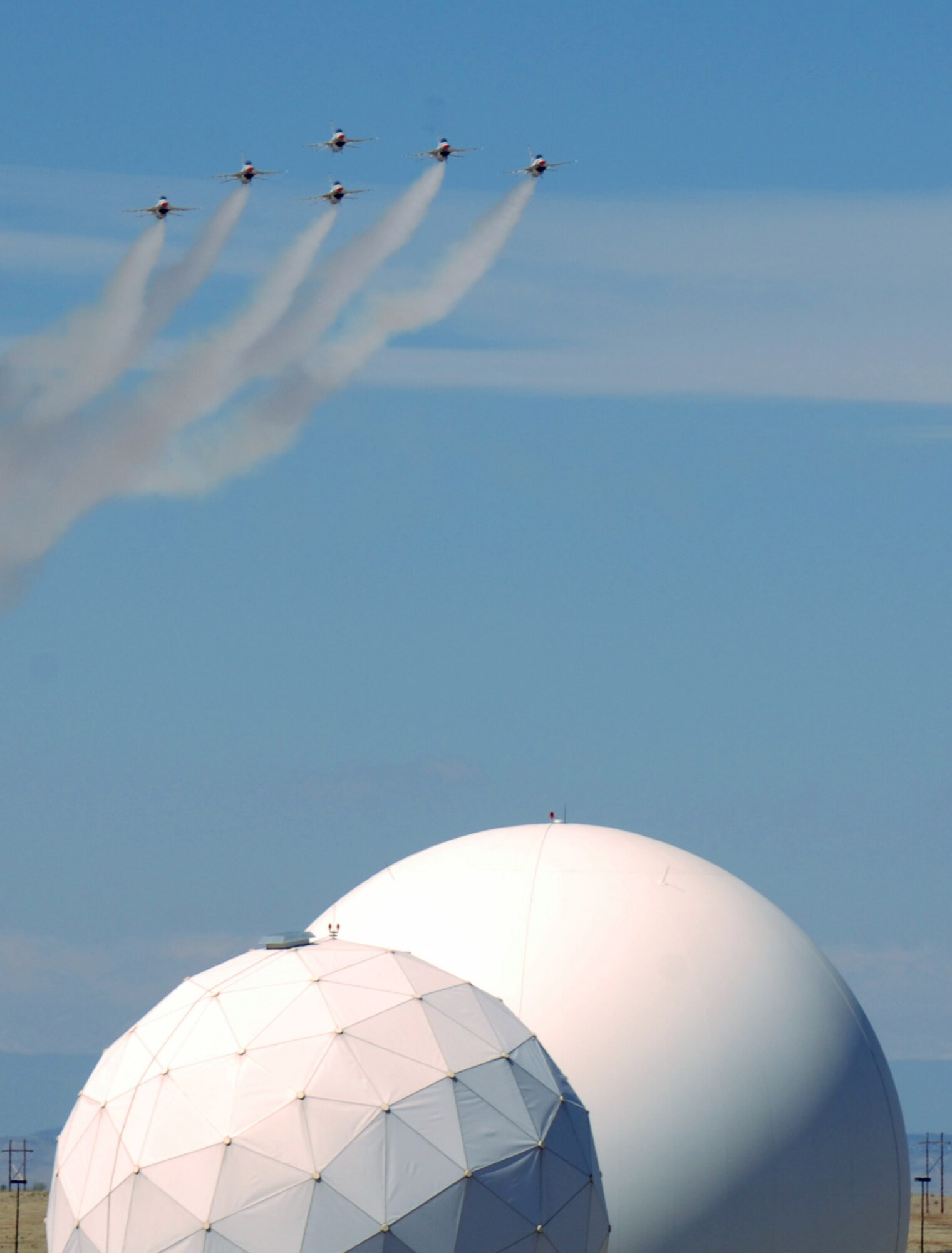 Airpower met space power at Schriever Air Force Base, Colo., as the U.S. Air Force Thunderbirds fly over the base May 25.  The Thunderbirds were in nearby Colorado Springs to perform at the Air Force Academy graduation May 28. (U.S. Air Force photo/Tech. Sgt. Martie Moore)