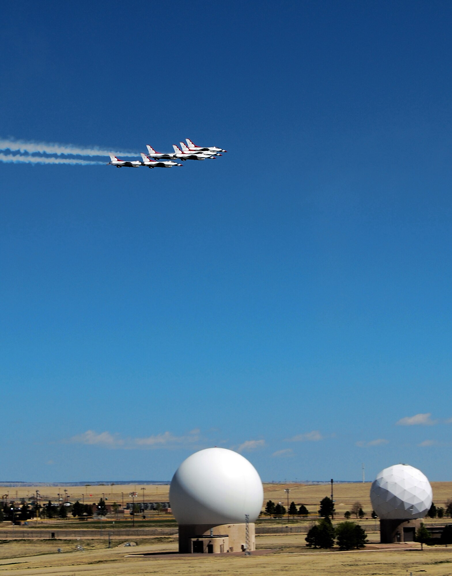 Airpower met space power at Schriever Air Force Base, Colo., as the U.S. Air Force Thunderbirds flew over the base May 25. The Thunderbirds were in nearby Colorado Springs to perform at the Air Force Academy graduation May 28. (U.S. Air Force photo/Staff Sgt. Don Branum)