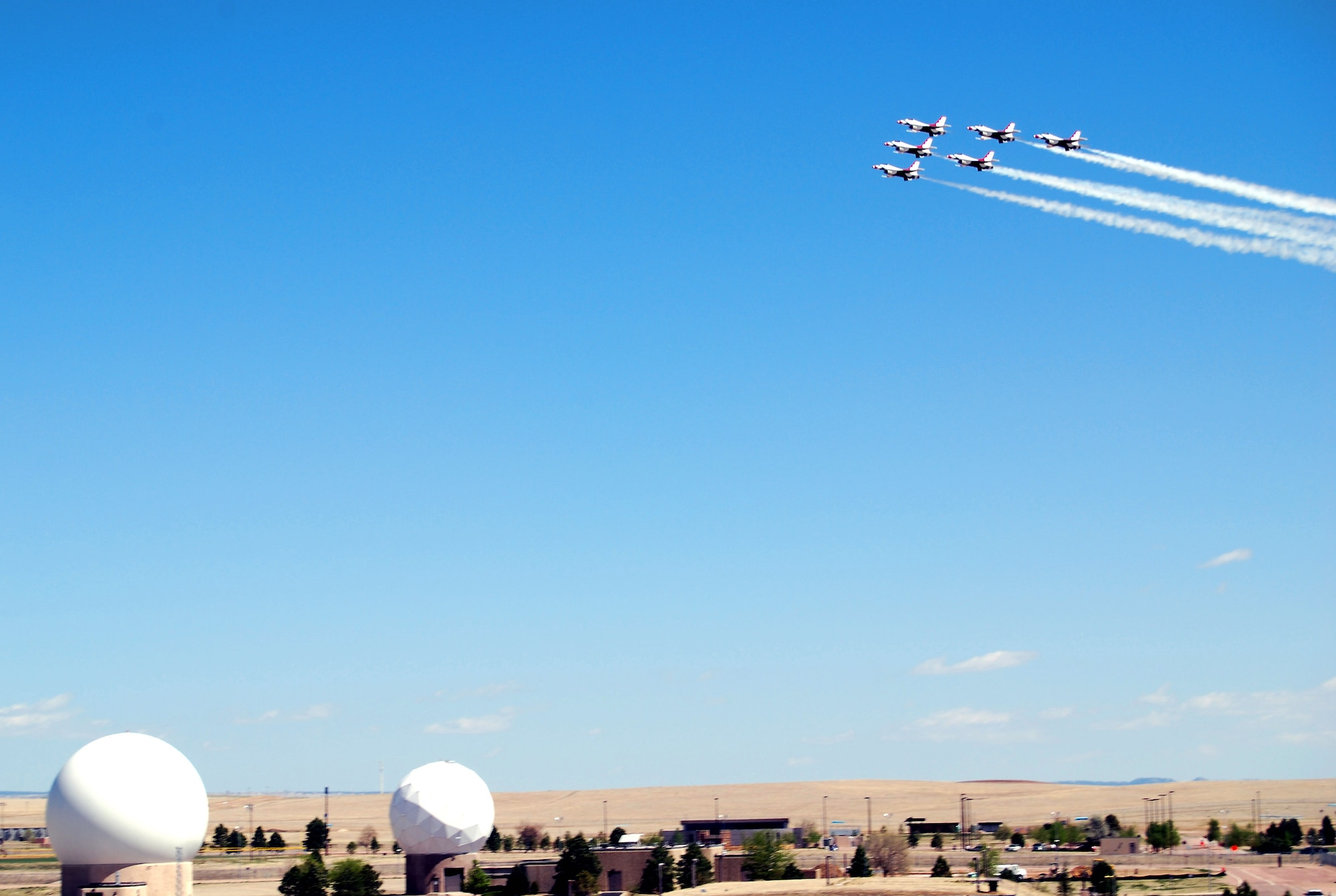 Airpower met space power at Schriever Air Force Base, Colo., as the U.S. Air Force Thunderbirds flew over the base May 25. The Thunderbirds were in nearby Colorado Springs to perform at the Air Force Academy graduation May 28. (U.S. Air Force photo/Staff Sgt. Don Branum)