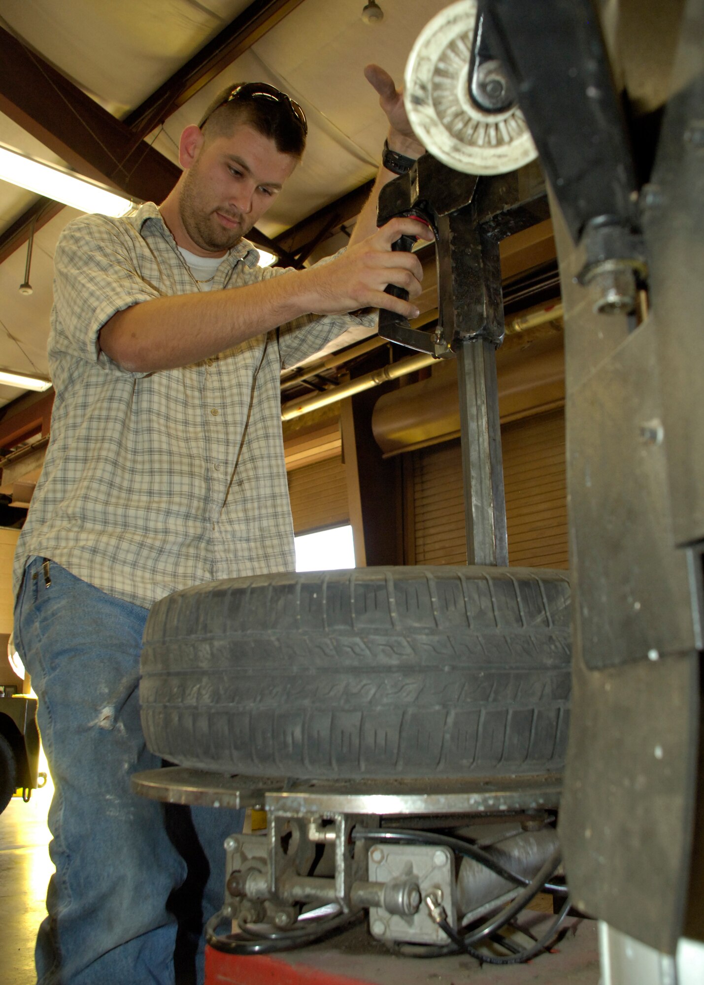 Mr. Jason Watson, tool and parts attendant, uses a tire machine to mount a tire at the Auto Hobby Center on Holloman Air Force Base, N.M., May 22. The center is staffed for your assistance and guidance if needed. (U.S. Air Force photo/Airman 1st Class Michael Means)