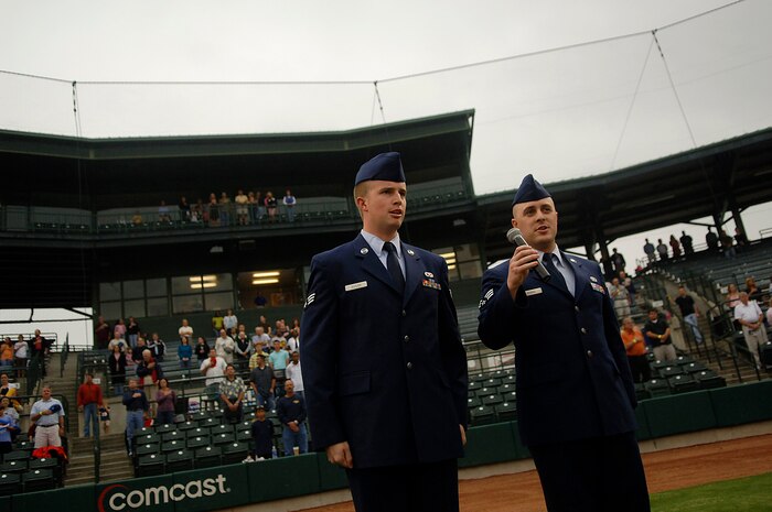 Senior Airmen Kris Butler and Sam Hymas sing the National Anthem to open the Charleston Riverdogs game at Joseph P. Riley Jr. Park in Charleston, S.C., May 29. The Riverdogs and Force Protection Industries Inc. organizations donated free tickets to thousands of base Airmen and family members to attend the game as a small token of appreciation for their service. Airman Butler is with the 437th Aircraft Maintenance Squadron and Airman Hymas is with the 437th Airlift Wing. (U.S. Air Force photo/Senior Airman Nicholas Pilch)