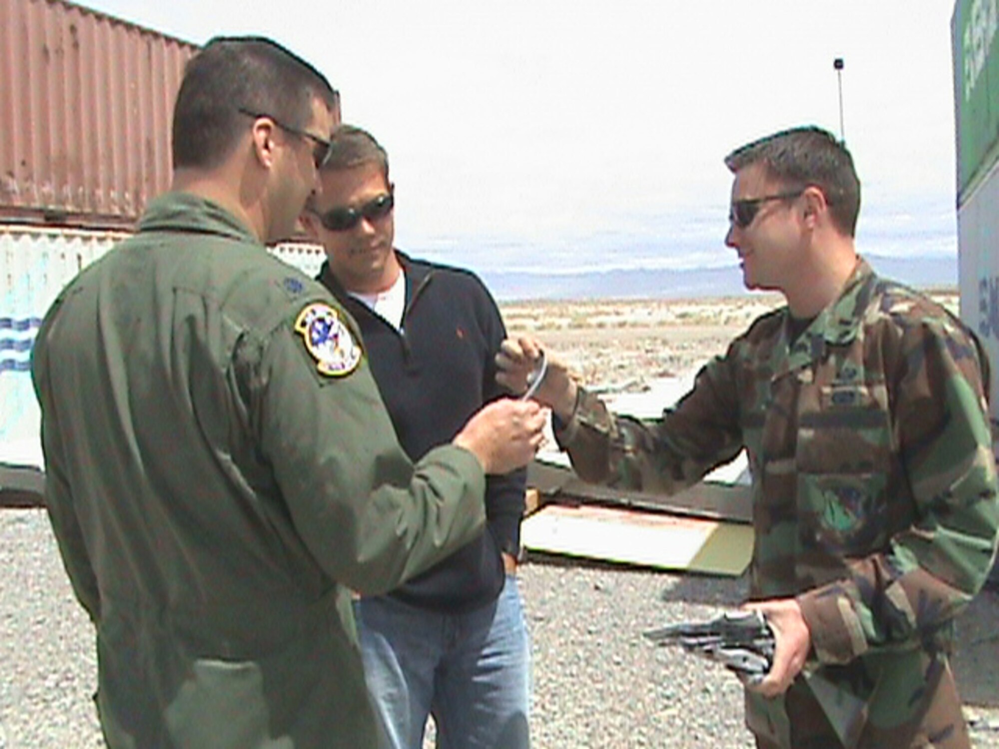HILL AIR FORCE BASE, Utah -- First Lt. Maximilien Reele, 86 Fighter Weapons Squadron Weapons and Tactics Analyst, shows, Lt. Col. Ostovich, 86 FWS commander and Sterling Riggs, 86 FWS honorary commander, pieces of a GBU that had hit it’s target at the Utah Test and Training Range.  The 86 FWS was there hosting a Weapons Evaluation Program System exercise.                   