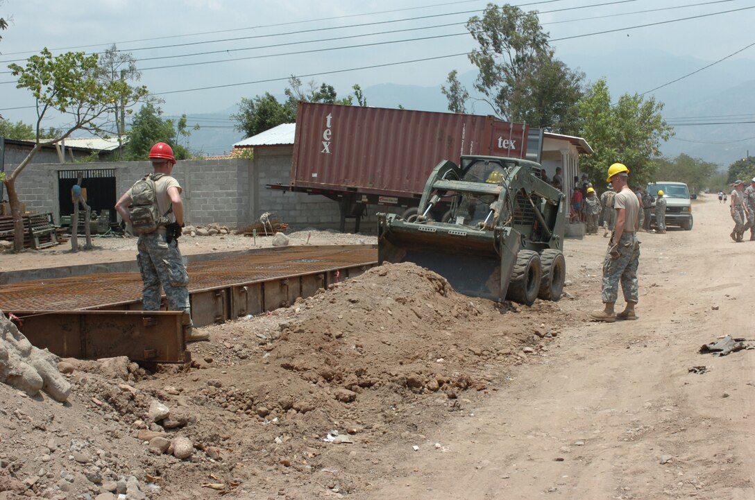 U.S. Soldiers from 389th Engineering Company grade the ground around a foundation as they renovate a schoolhouse, in La Granja, Honduras, May 2, 2008. The renovation is part of Beyond the Horizons, a joint training exercise designed to provide missions that improve the quality of life for the local populace while fostering partnership between U.S. and Honduran forces.  (U.S. Army photo by Staff Sergeant Sean A. Foley)(Released)