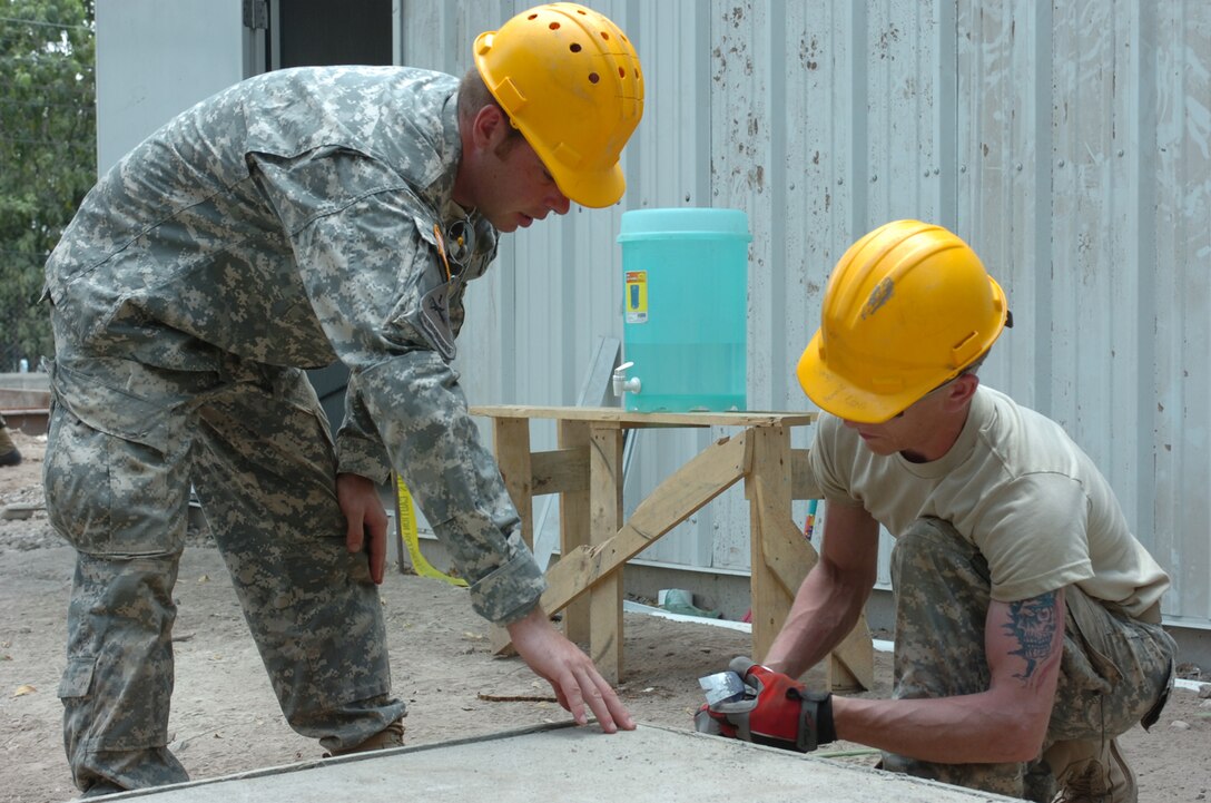 U.S. Army Sergeant (SGT) Steven Wincentsen explains to Specialist (SPC)Kent Horstman, both Engineers with 389th Engineering Company, the proper way to free a cured concrete slab from its form during renovation at a school in La Granja, Honduras, May 2, 2008.  The renovation is part of Beyond the Horizons, a joint training exercise designed to provide missions that improve the quality of life for the local populace while fostering partnership between U.S. and Honduran forces. (U.S. Army photo by Staff Sergeant Sean A. Foley)(Released)