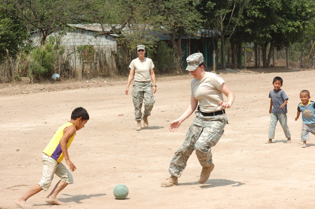 U.S. Army Specialist Teri McMurray, a Medic with 4005th Army Hospital, takes time to play soccer with local children while providing medical support at a school renovation site, in La Mesas, Honduras, May 2, 2008.  The 4005th Army Hospital is taking part in Beyond the Horizons, a joint training exercise providing goodwill while presenting real world challenges for engineer, medical Civil Affair and Military Police units. (U.S. Army photo by Staff Sergeant Sean A. Foley)(Released)