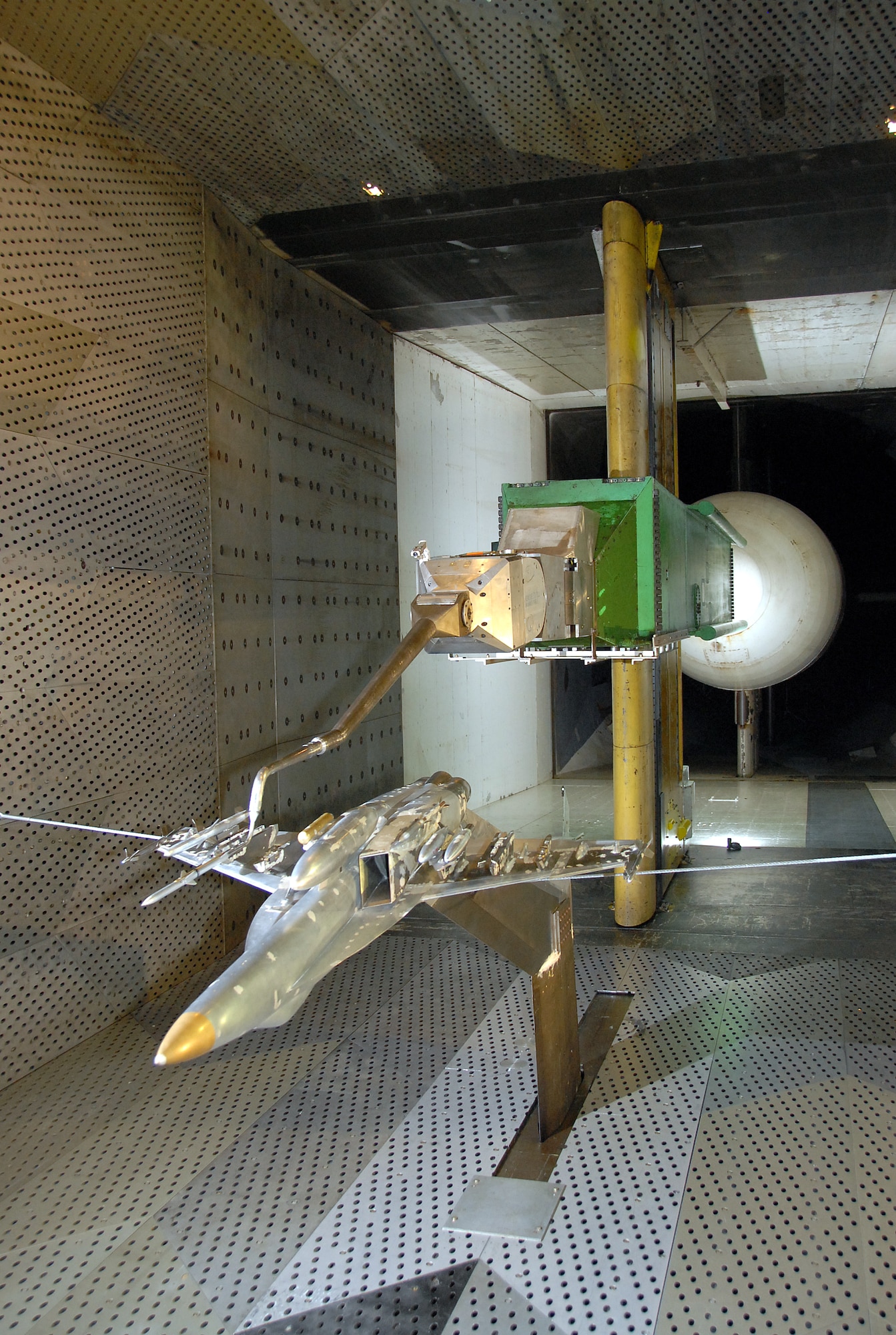 This is a view of 1/10-scale sting-mounted AIM-120C store and F/A-18E/F aircraft models during a break in store separation testing inside AEDC’s 16-foot transonic wind tunnel. (Photo by David Housch)