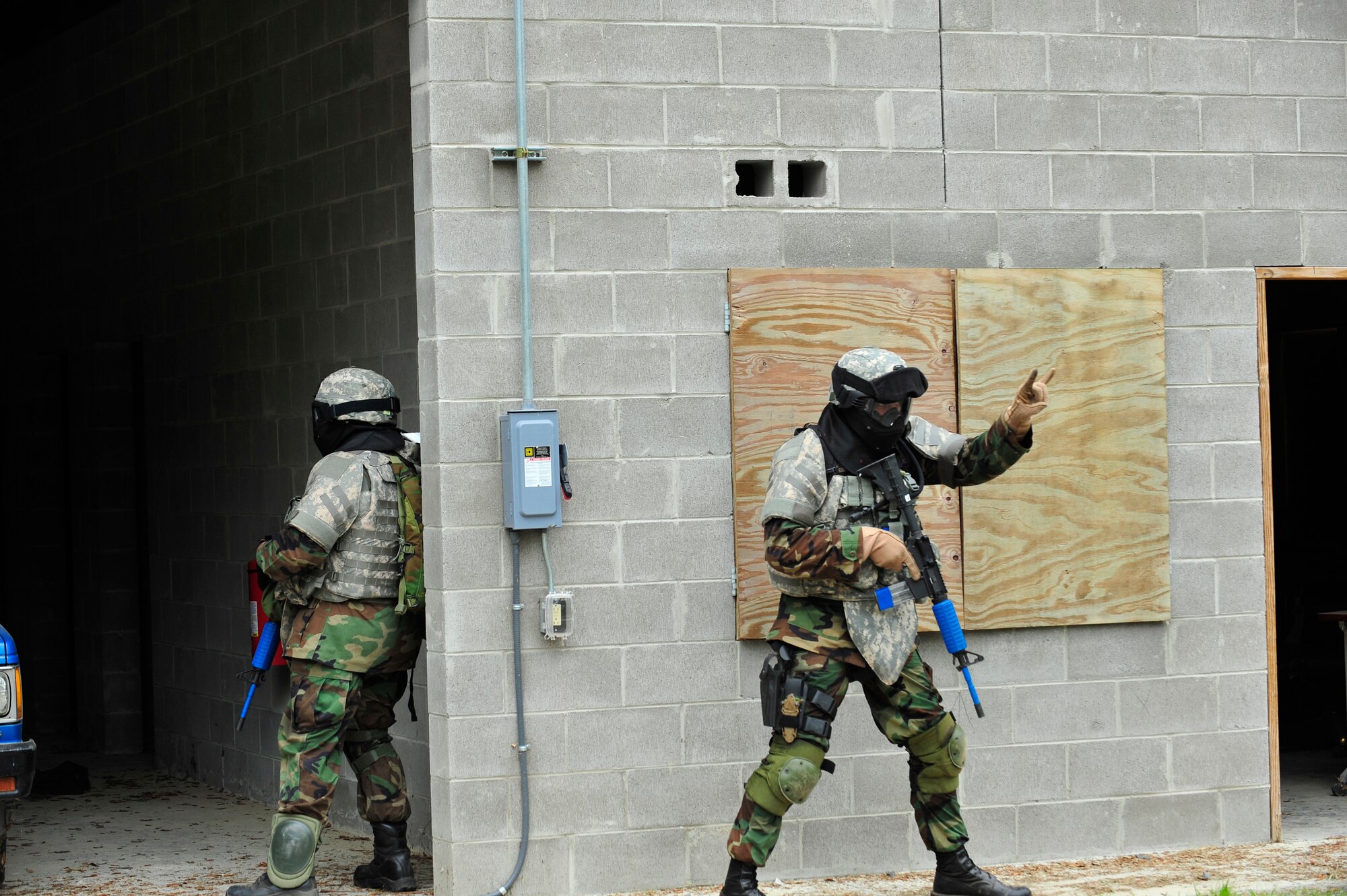 MOODY AIR FORCE BASE, Ga -- Capt. Ian Dinesen, 820th Security Forces Group operations officer, communicates that two enemy prisoners of war have been identified in a building during combat medical skills training here May 22 . (U.S. Air Force photo by Senior Airman Schelli Jones)